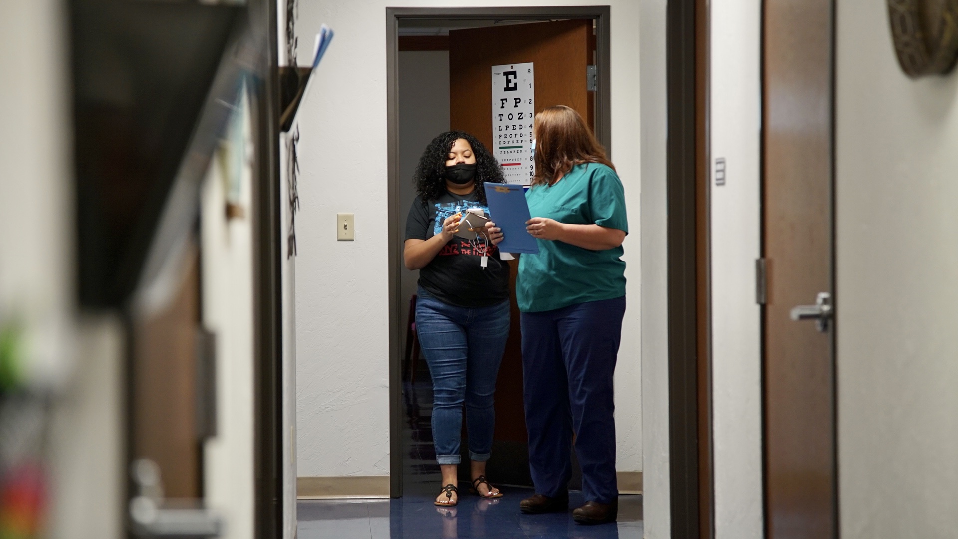 JASMINE AND A WORKER AT OKLAHOMA CITY'S TRUST WOMEN CLINIC WALK DOWN A HALL.