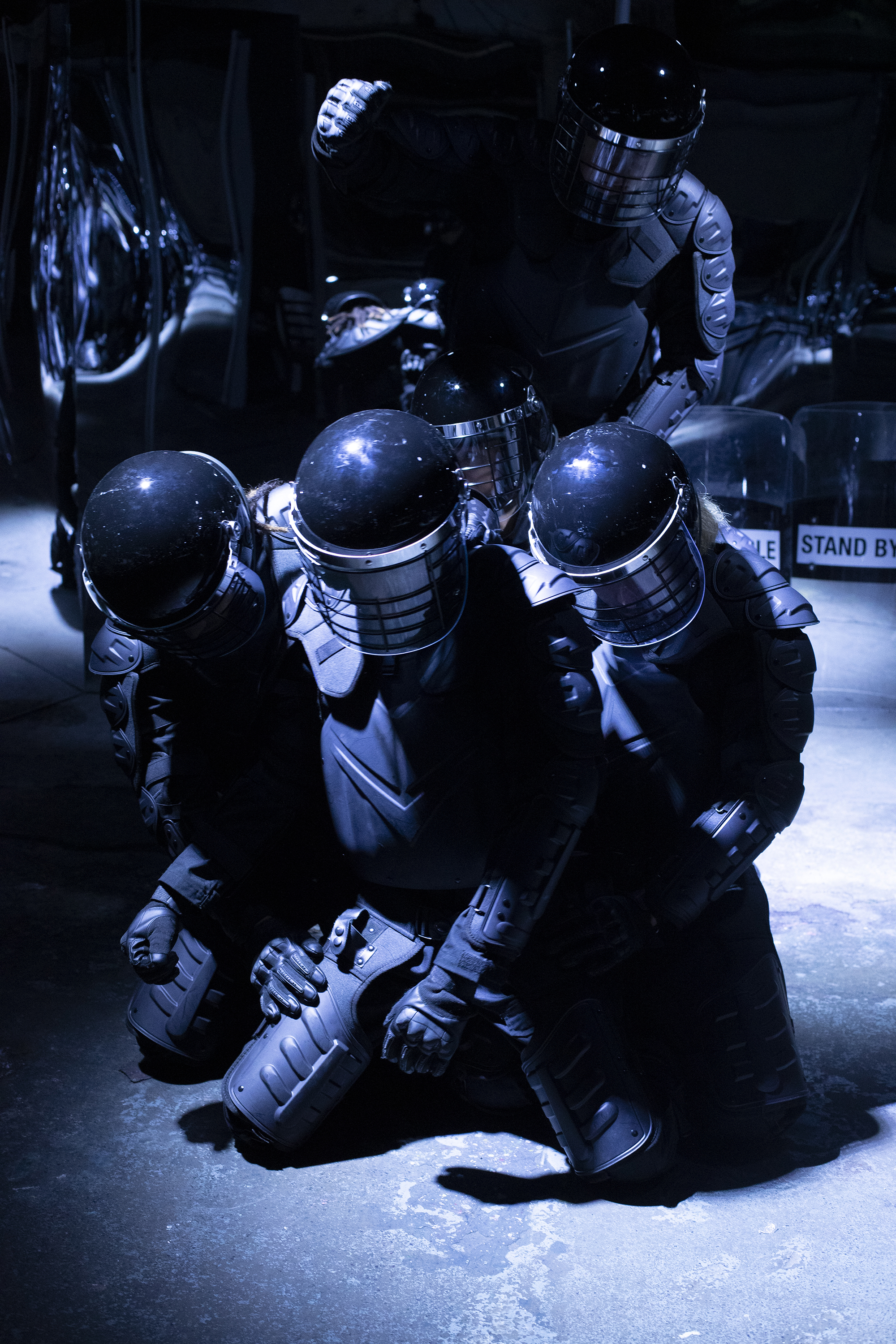 people in riot gear simulate fighting
