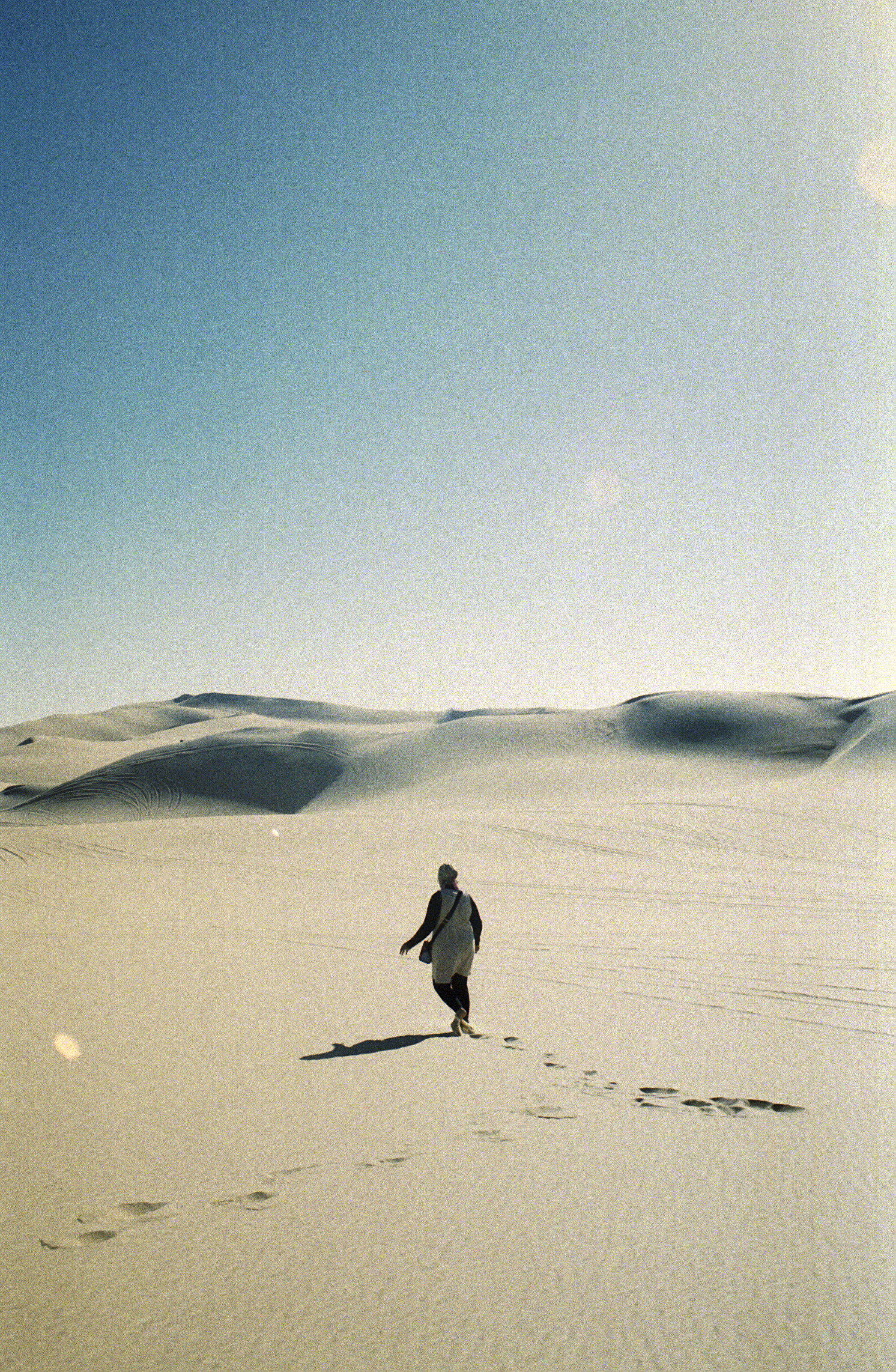 woman walks through the dessert sands
