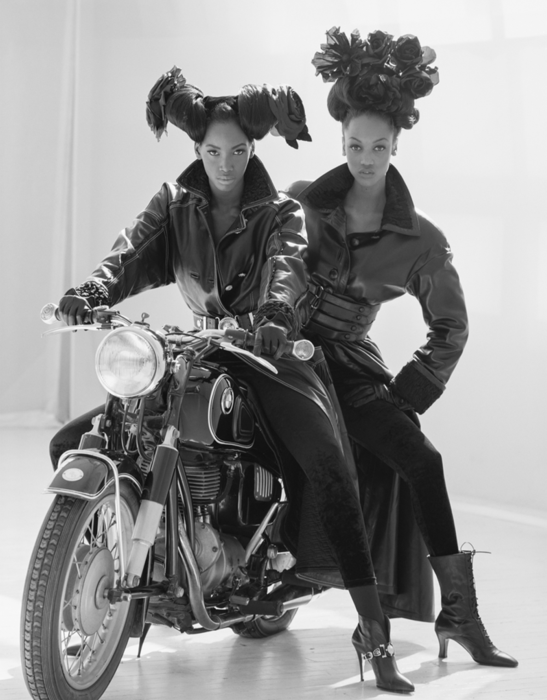 Beverly Peele and Tyra Banks posing on a motorcycle in leather jackets by arthur elgort 1993