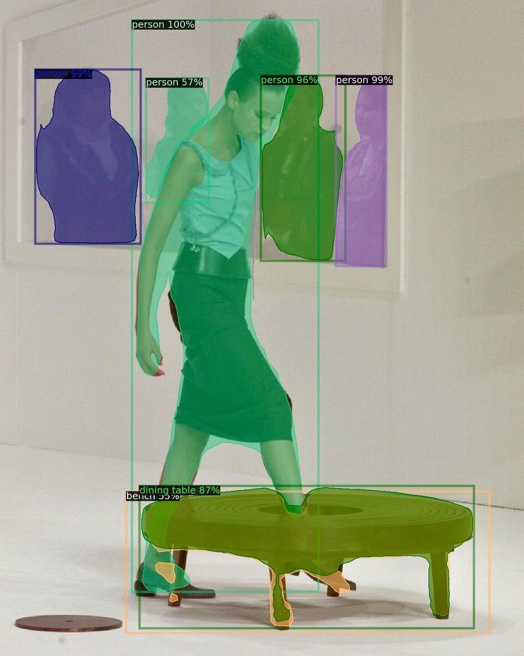 A digital image of a model stepping into the Hussein Chalayan table dress
