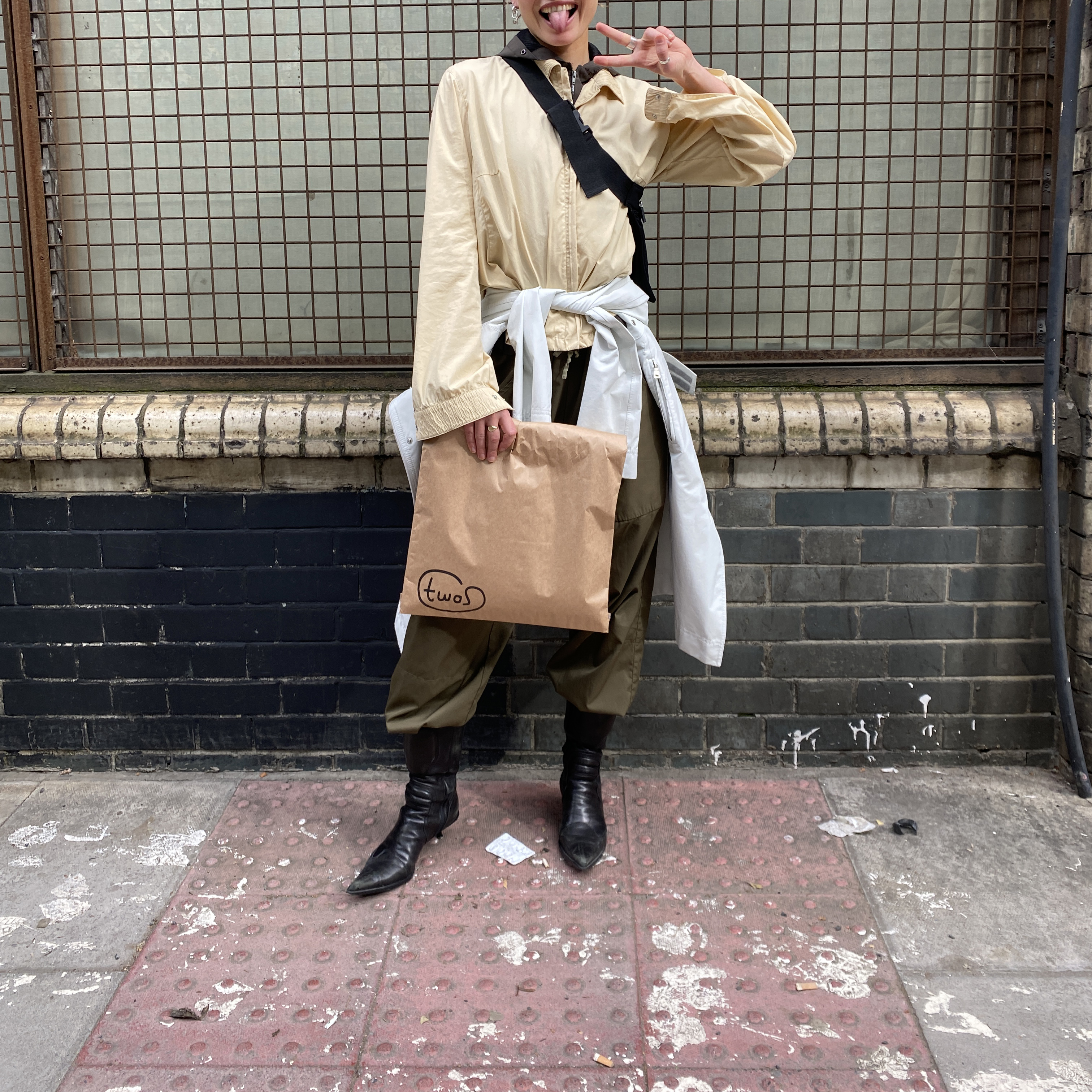 A people holding a brown paper bag 