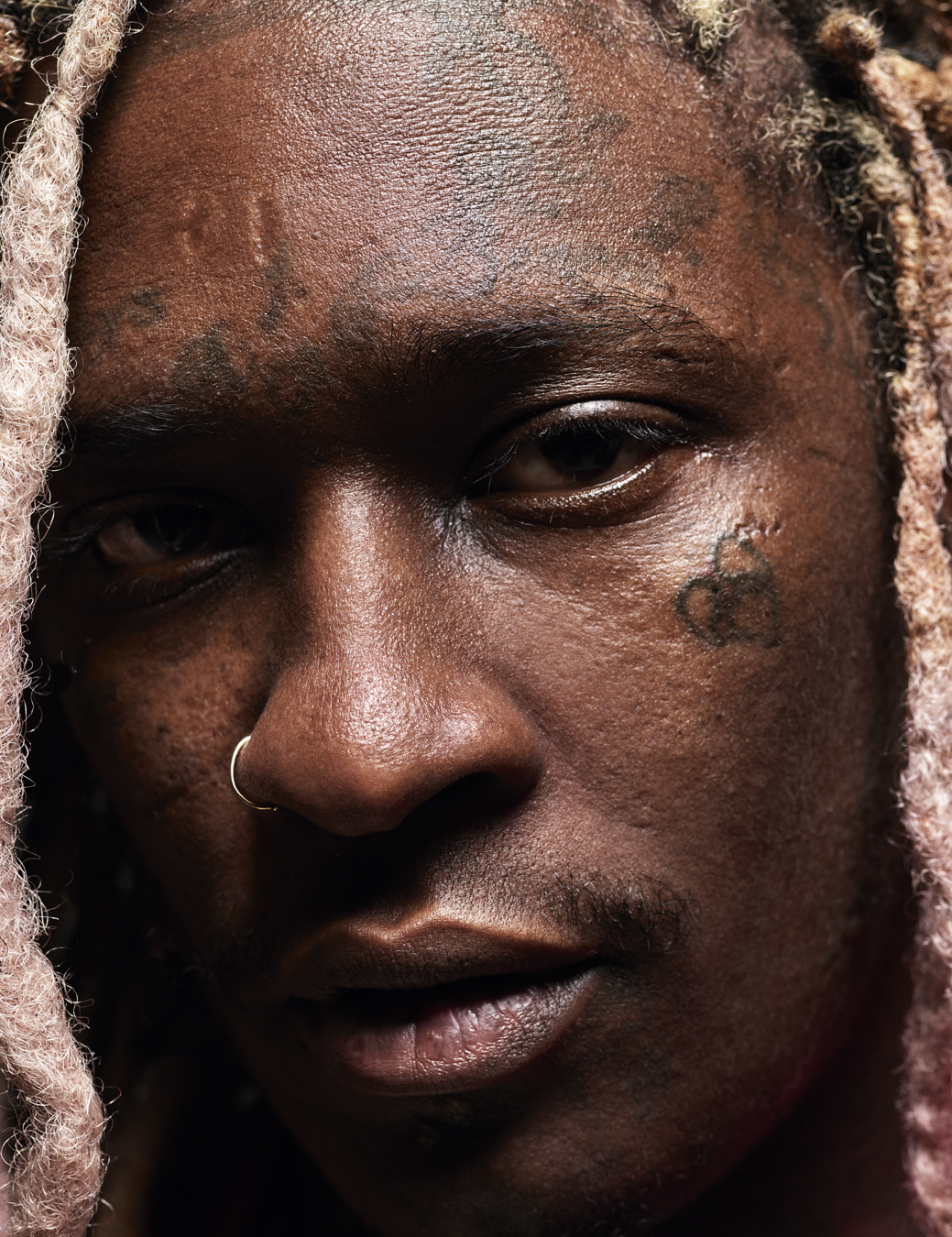 Close up of Young Thug's face with a nose ring. 