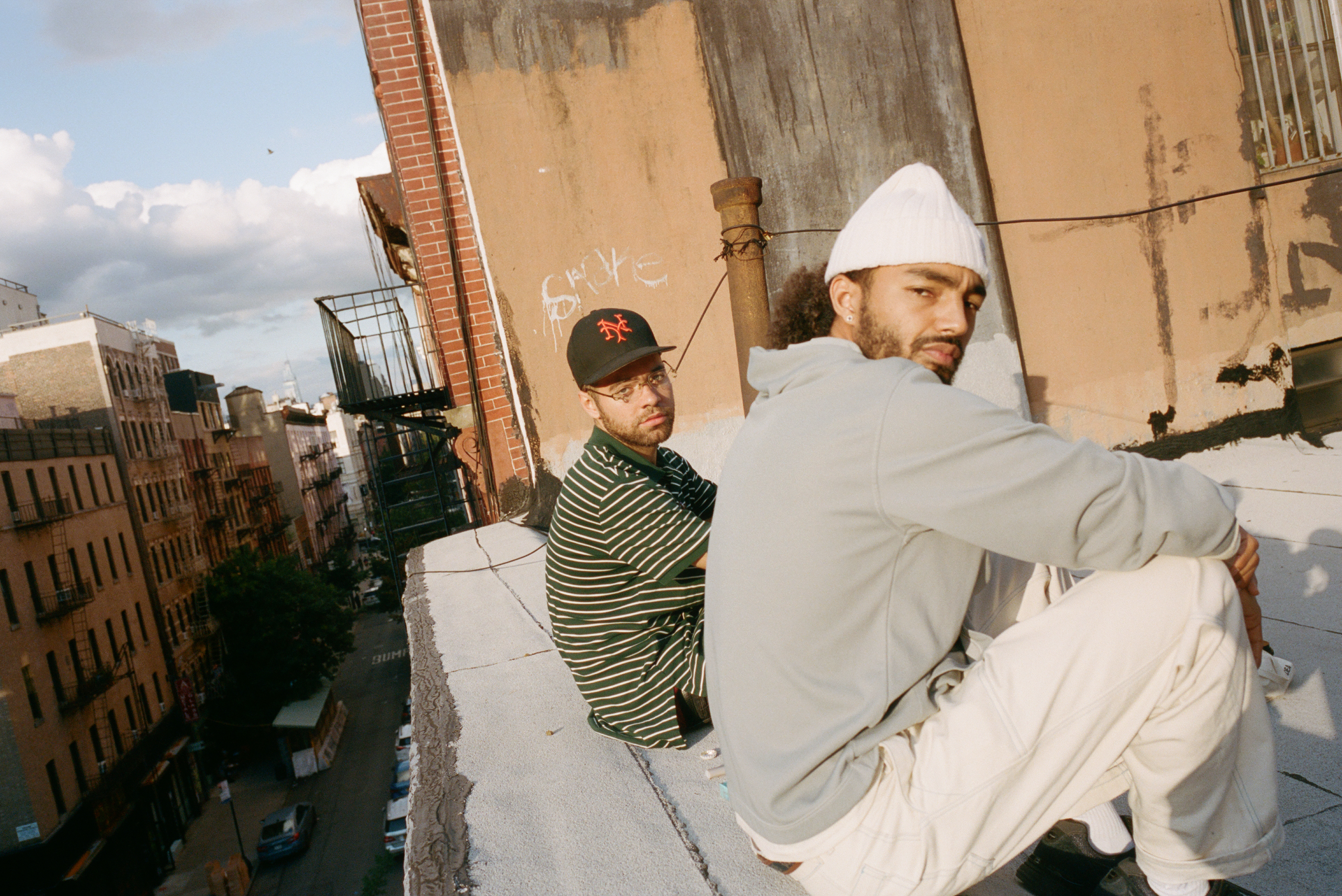 wiki and sage elsesser sitting on the edge of a new york rooftop