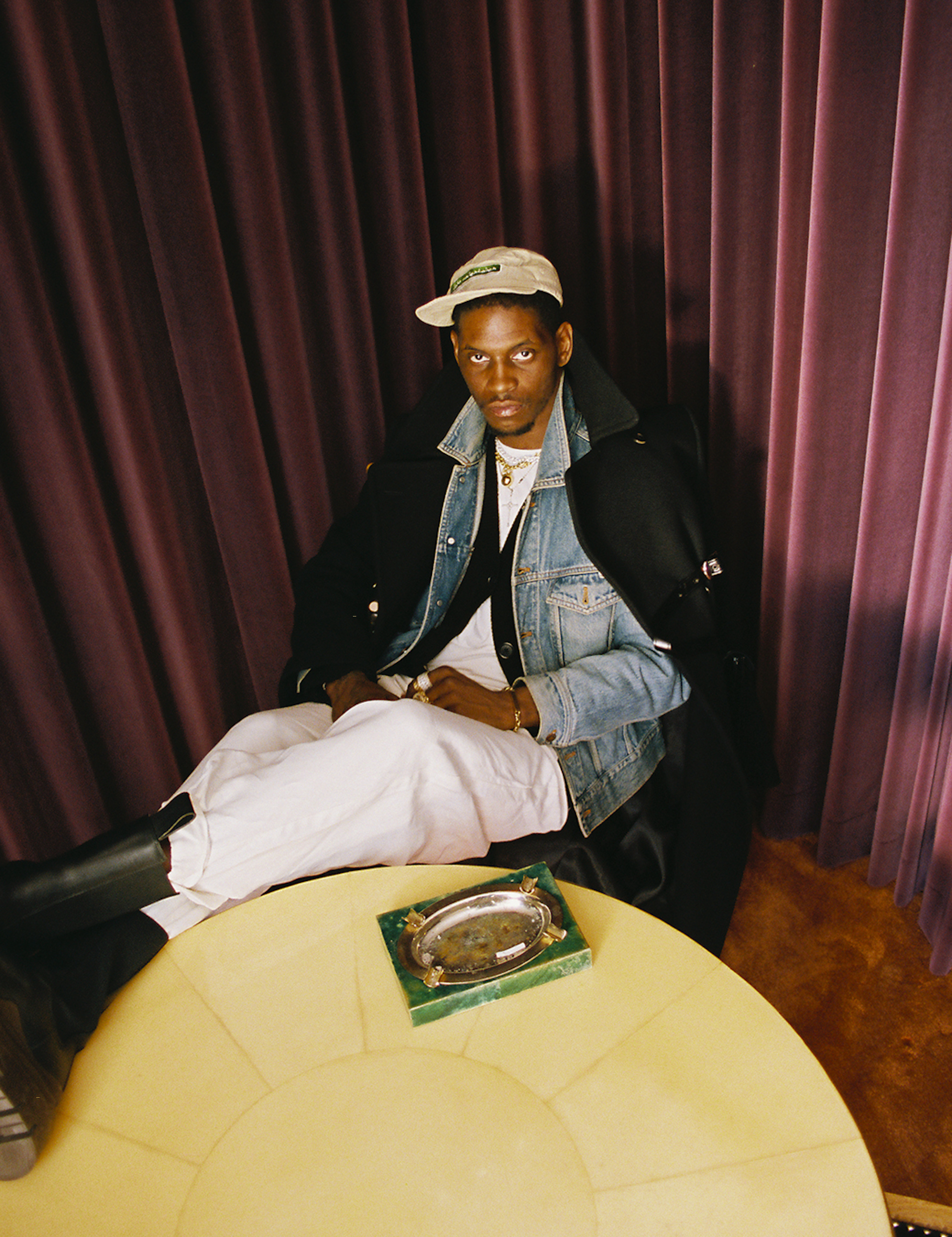 A$AP Nast sitting on a chair with his boots on a table photographed by Bladimir Corniel