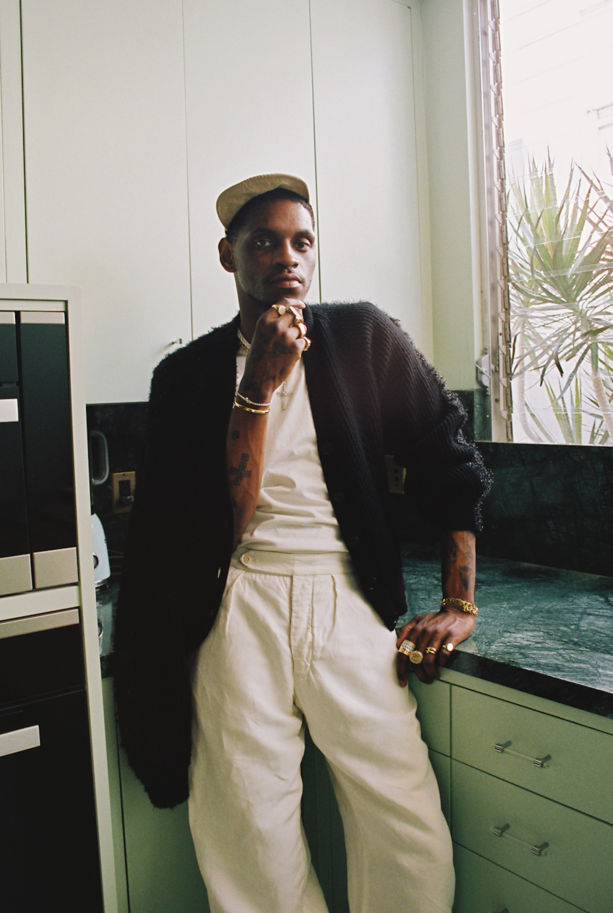 A $ AP Nast leaning against the kitchen table photographed by Bladimir Corniel