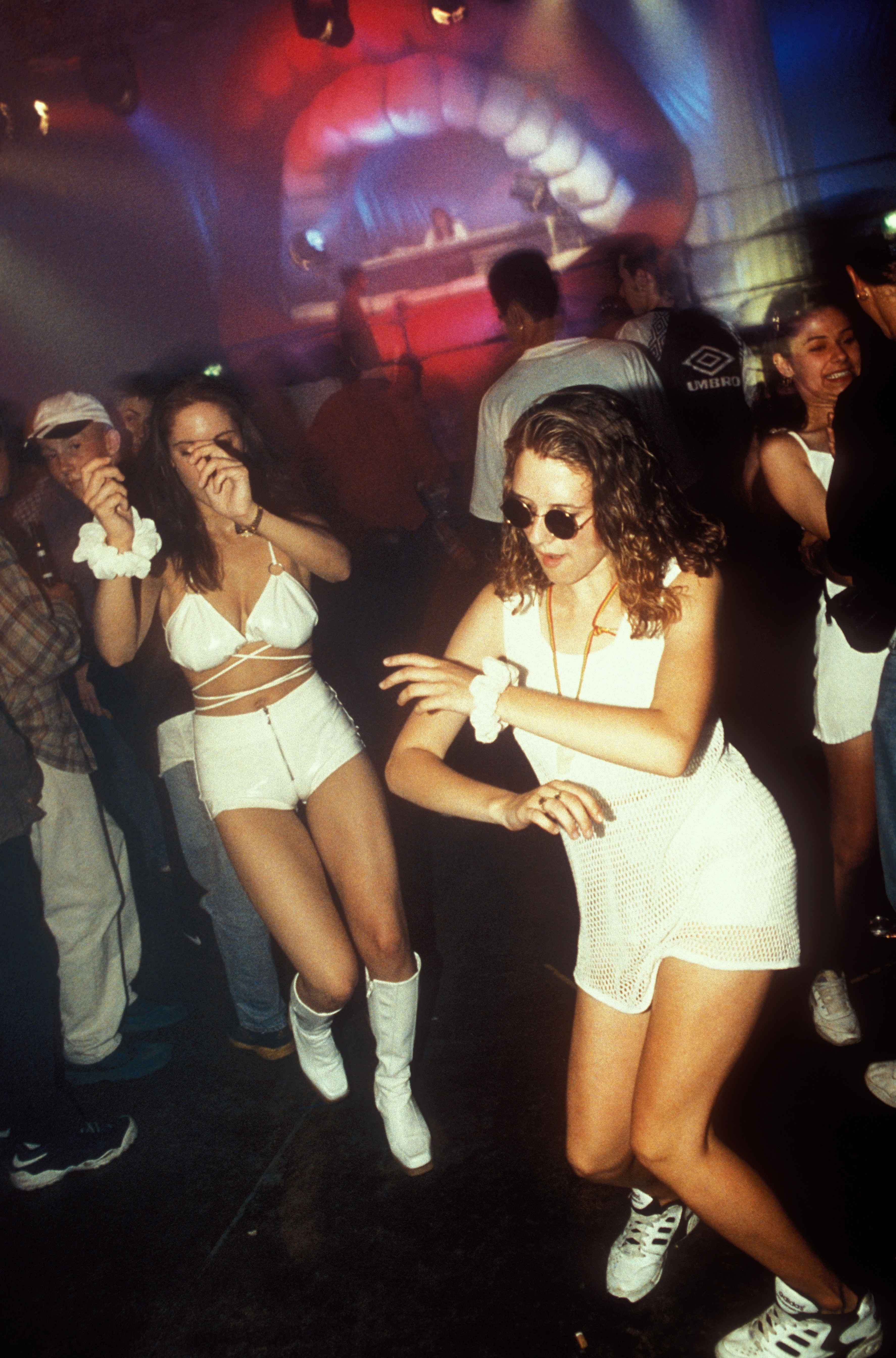 90s ravers dance in a club 