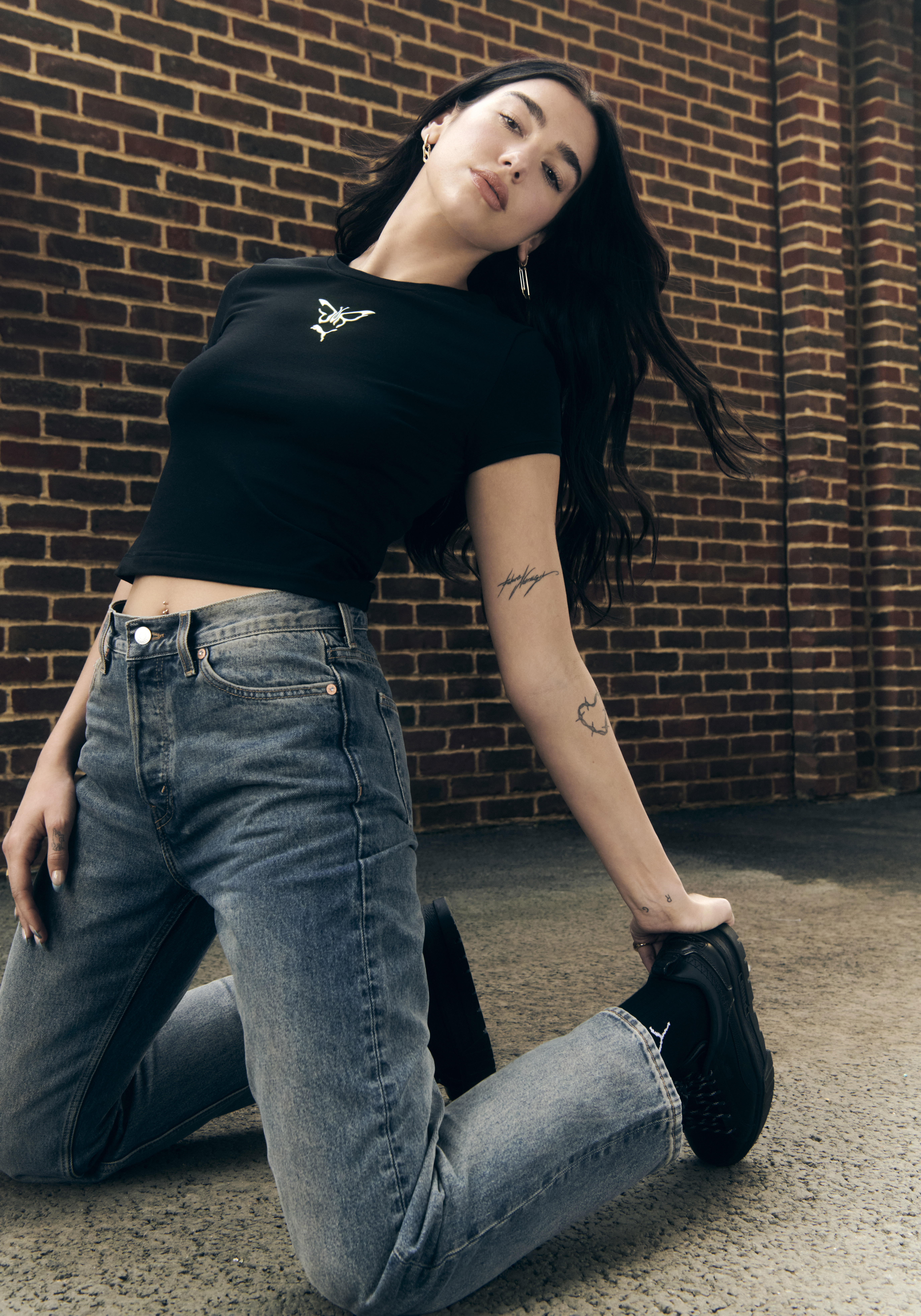Dua Lipa poses wearing her new Flutur x PUMA collection