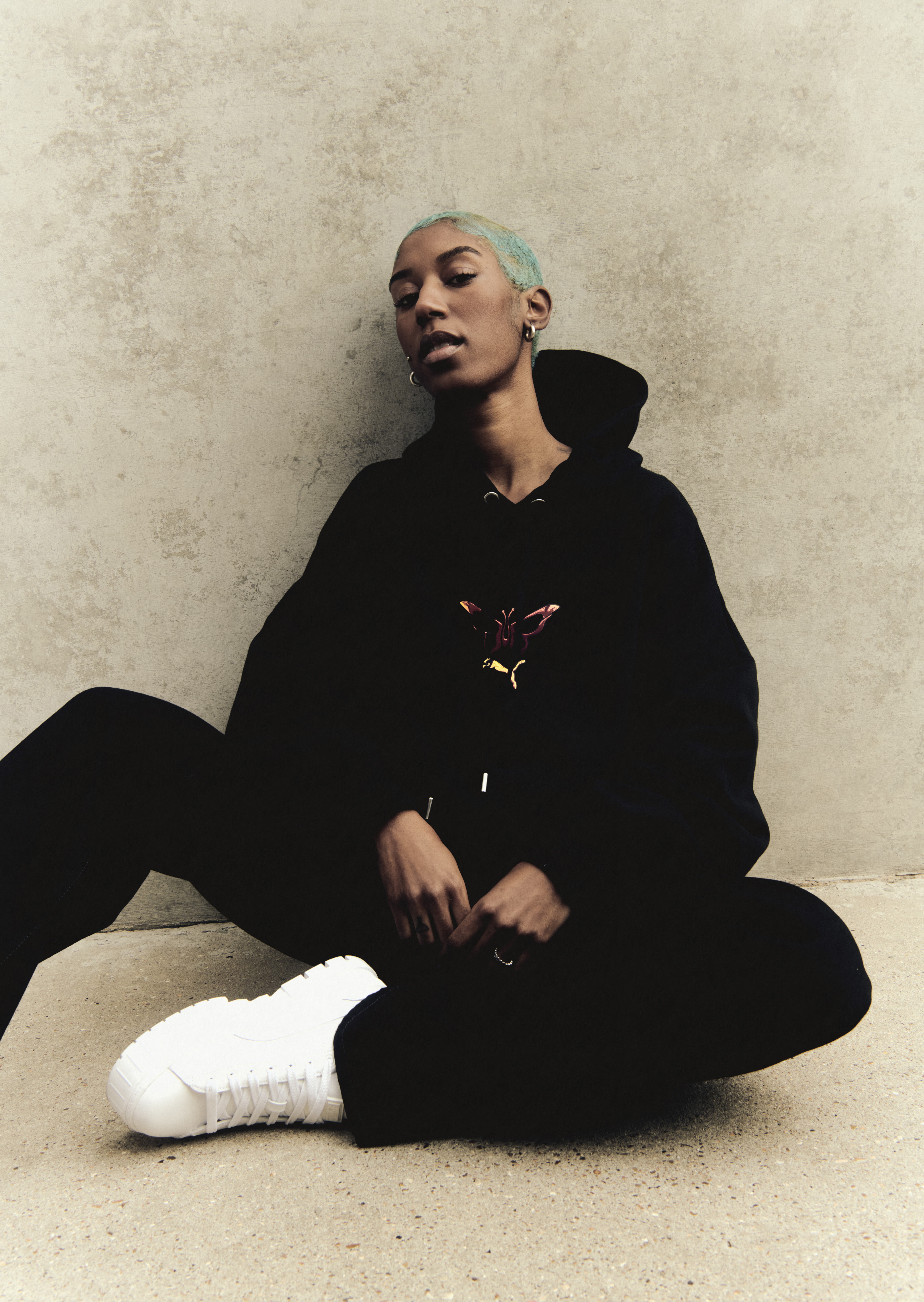 a model poses wearing Dua Lipa's new Flutur x PUMA collection