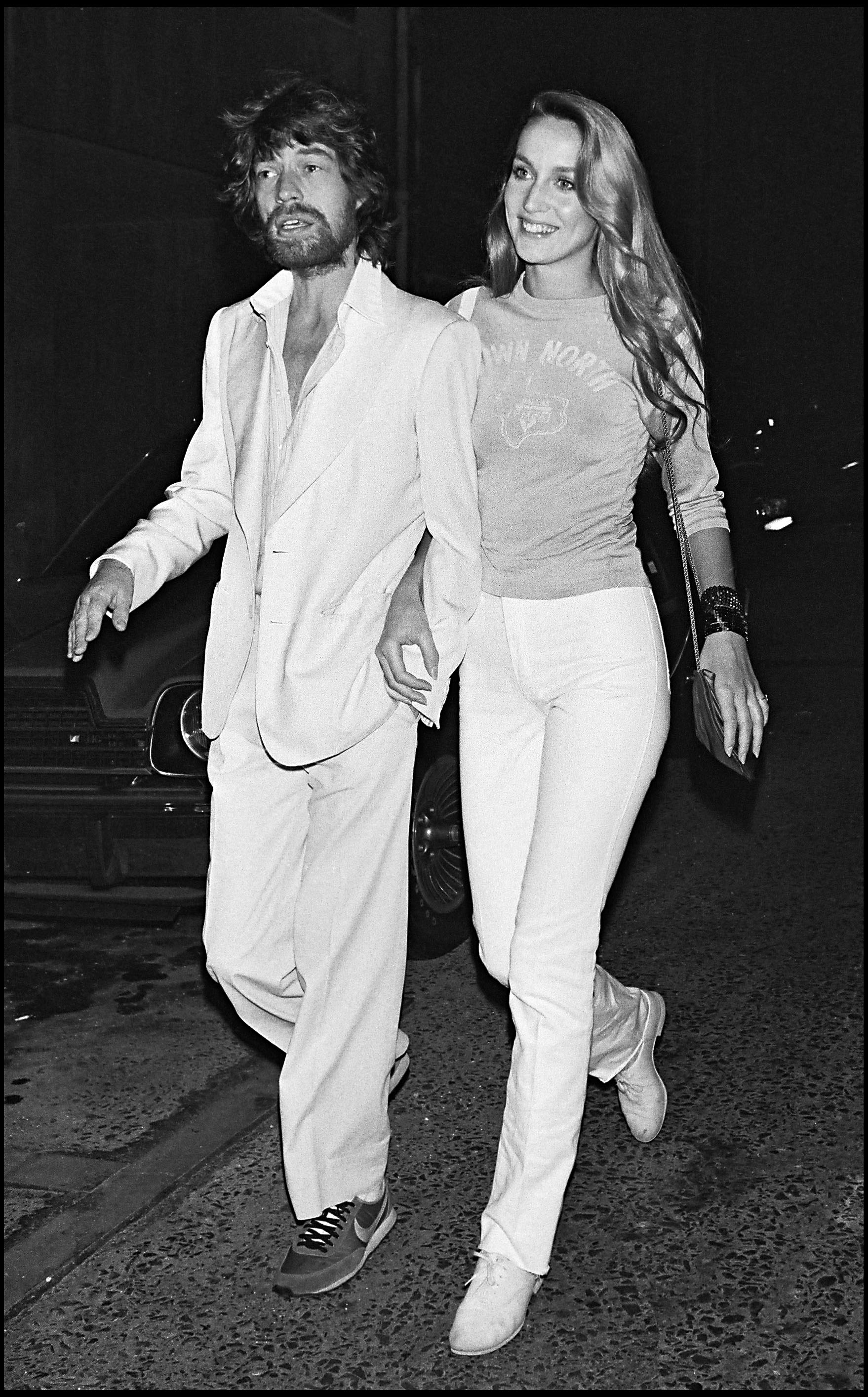 Jerry Hall and Mick Jagger walking the streets 1979