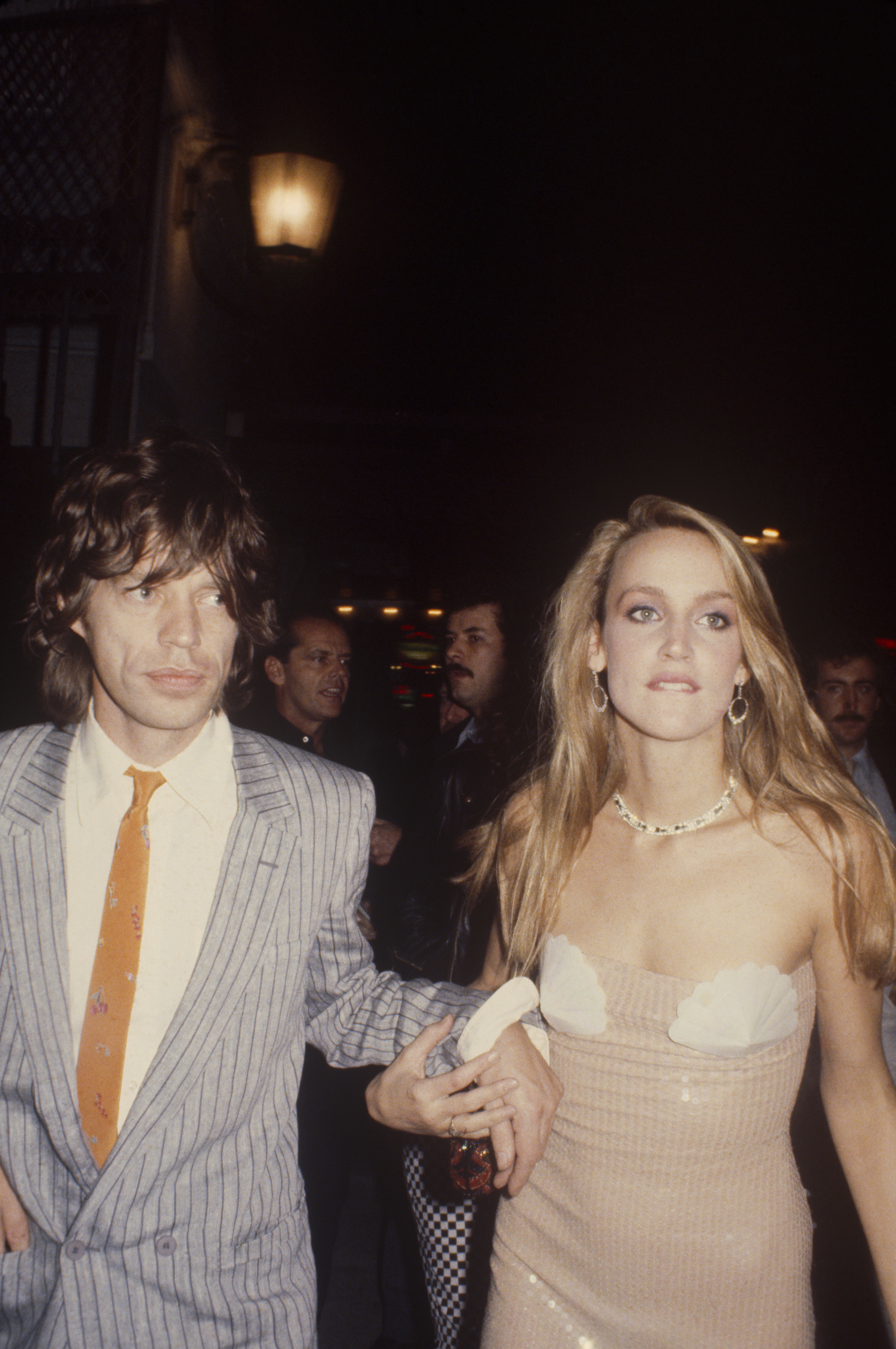Jerry Hall in a sequined mermaid dress and Mick Jagger in a 1981 pinstripe suit