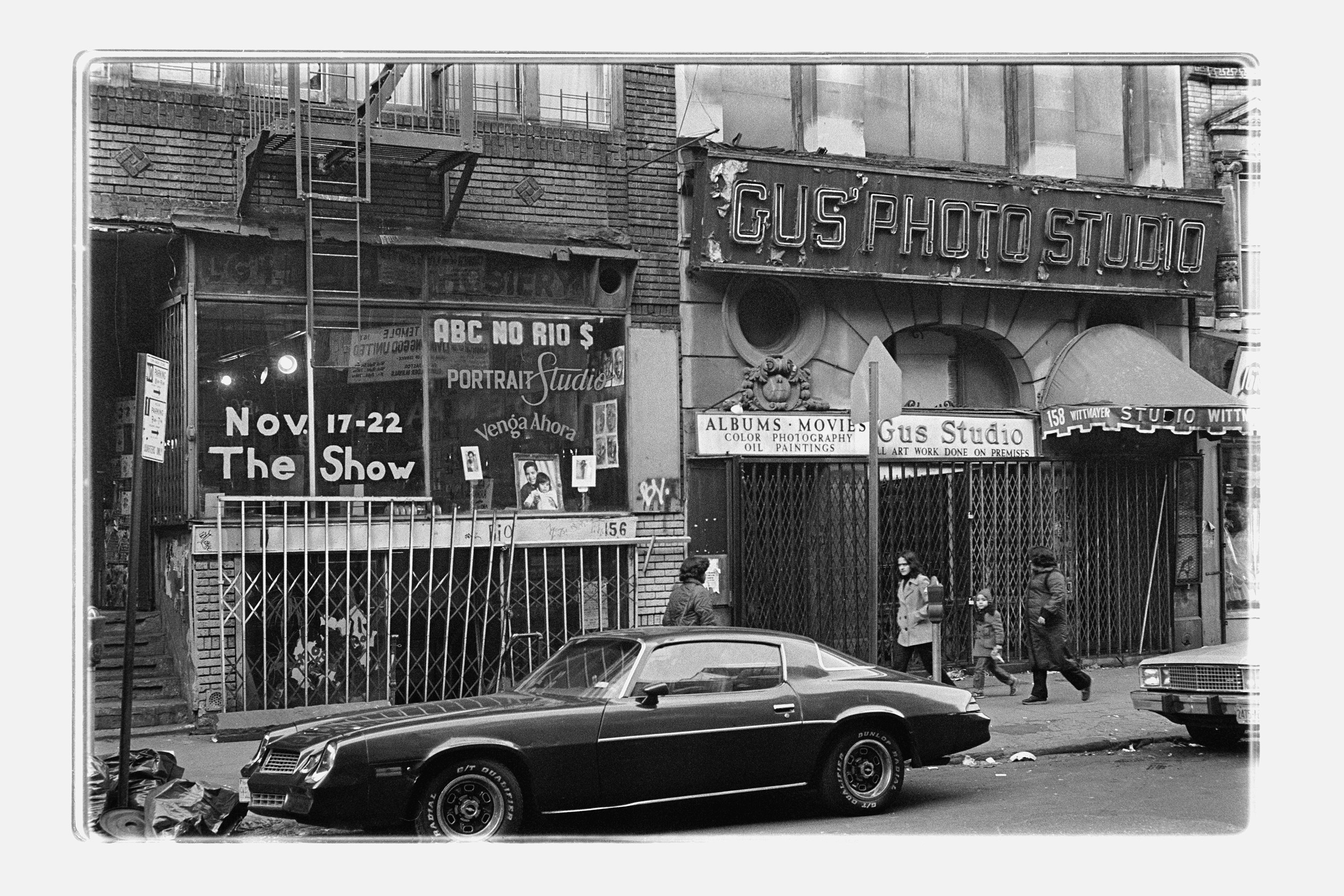 a black and white photo of a car outside ABC No Rio on Rivington Street in New York 1981