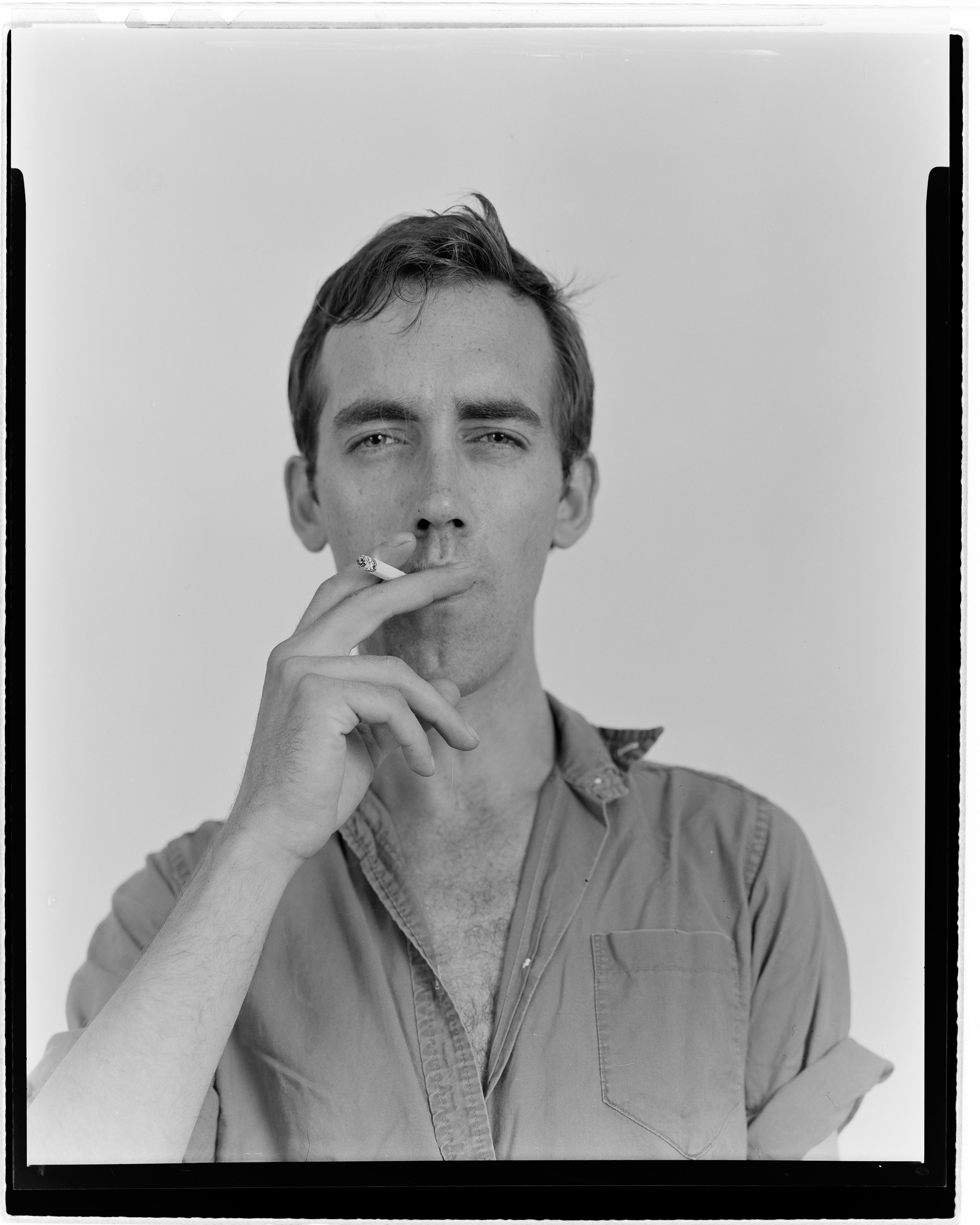 a black and white portrait of David Wojnarowicz smoking a cigarette in 1983 by tom warren