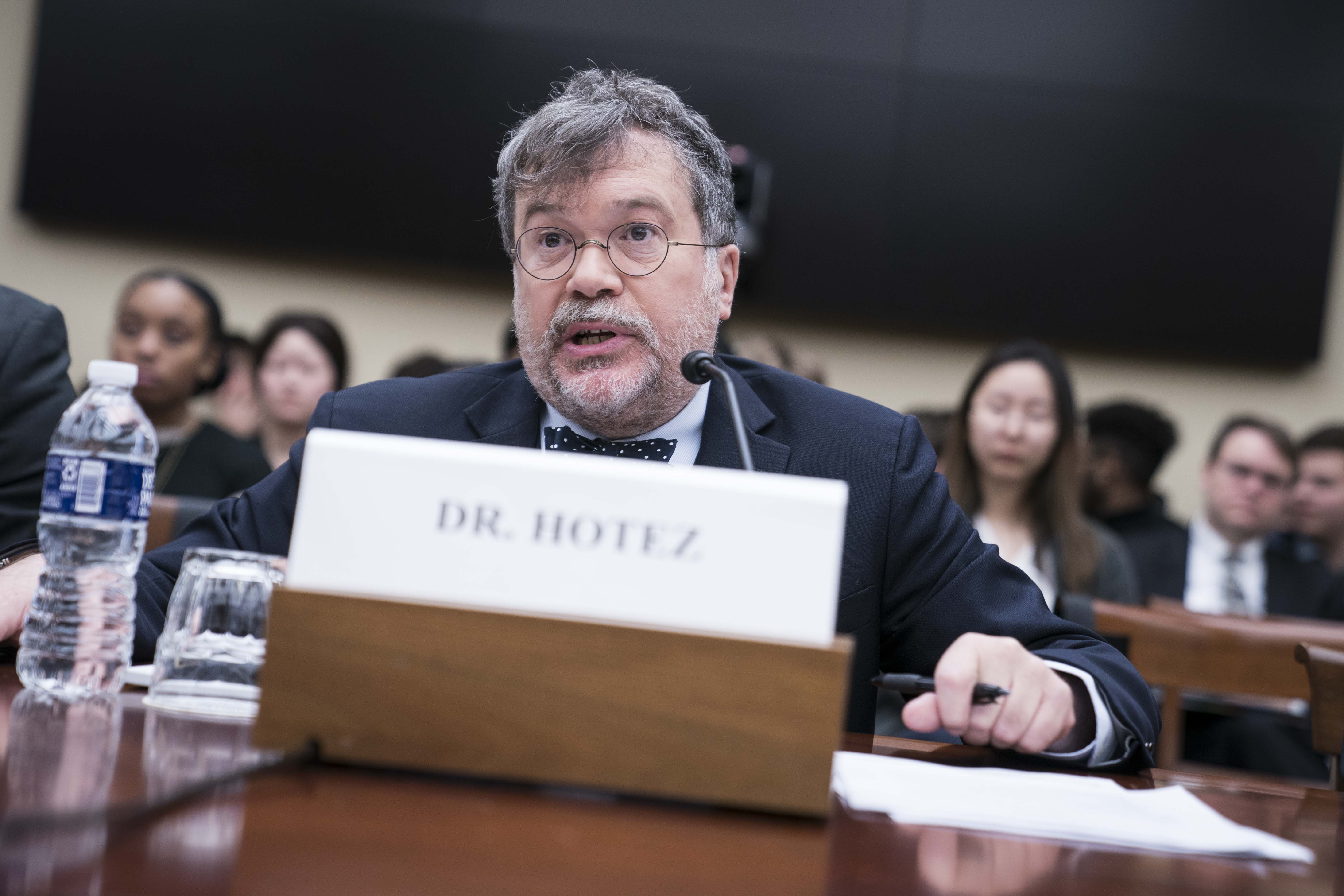 Dr. Peter Hotez sits behind a name placard at a Congressional hearing in 2020.
