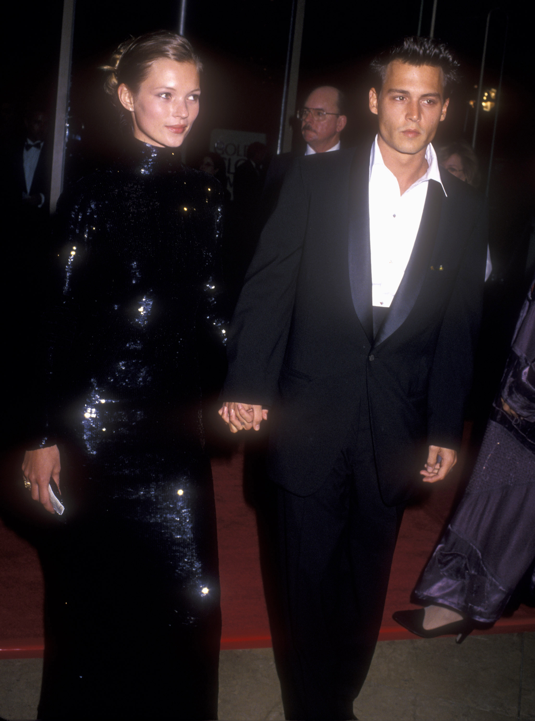 kate moss wearing a sequinned gown with johnny depp at the golden globes 1995