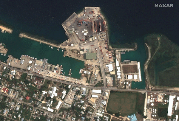This combination of satellite images released by Maxar Technologies on January 18, 2022 shows a before (top) image taken on December 29, 2021 and an after image taken on January 18, 2022 of the main port facilities in Nuku’alofa, the capital of Tonga, covered in ash following the eruption of the Hunga-Tonga - Hunga-Haa'pai volcano on January 15. Handout / Satellite image ©2022 Maxar Technologies / AFP