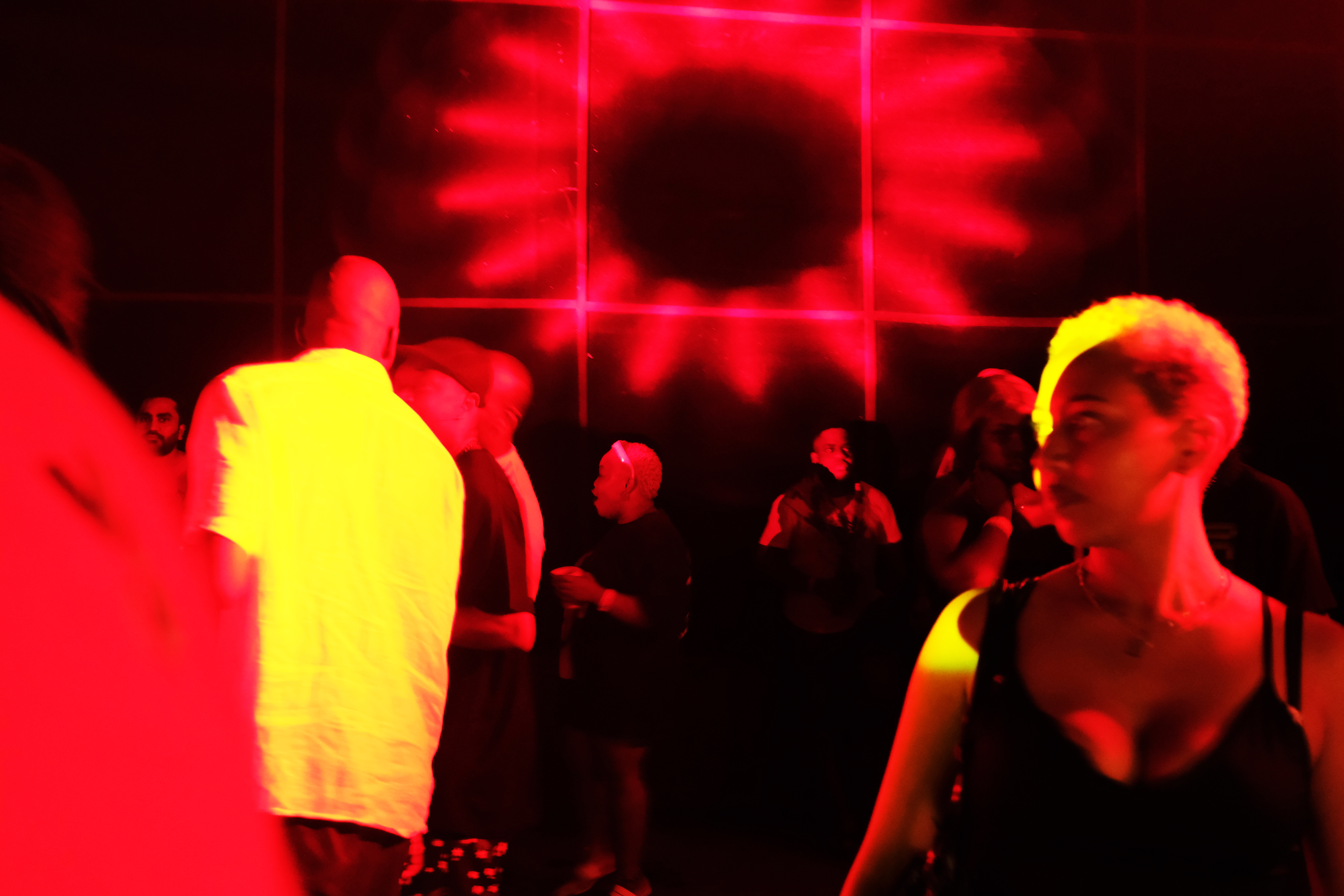 a shot of an EDM rave in Lagos with red lighting