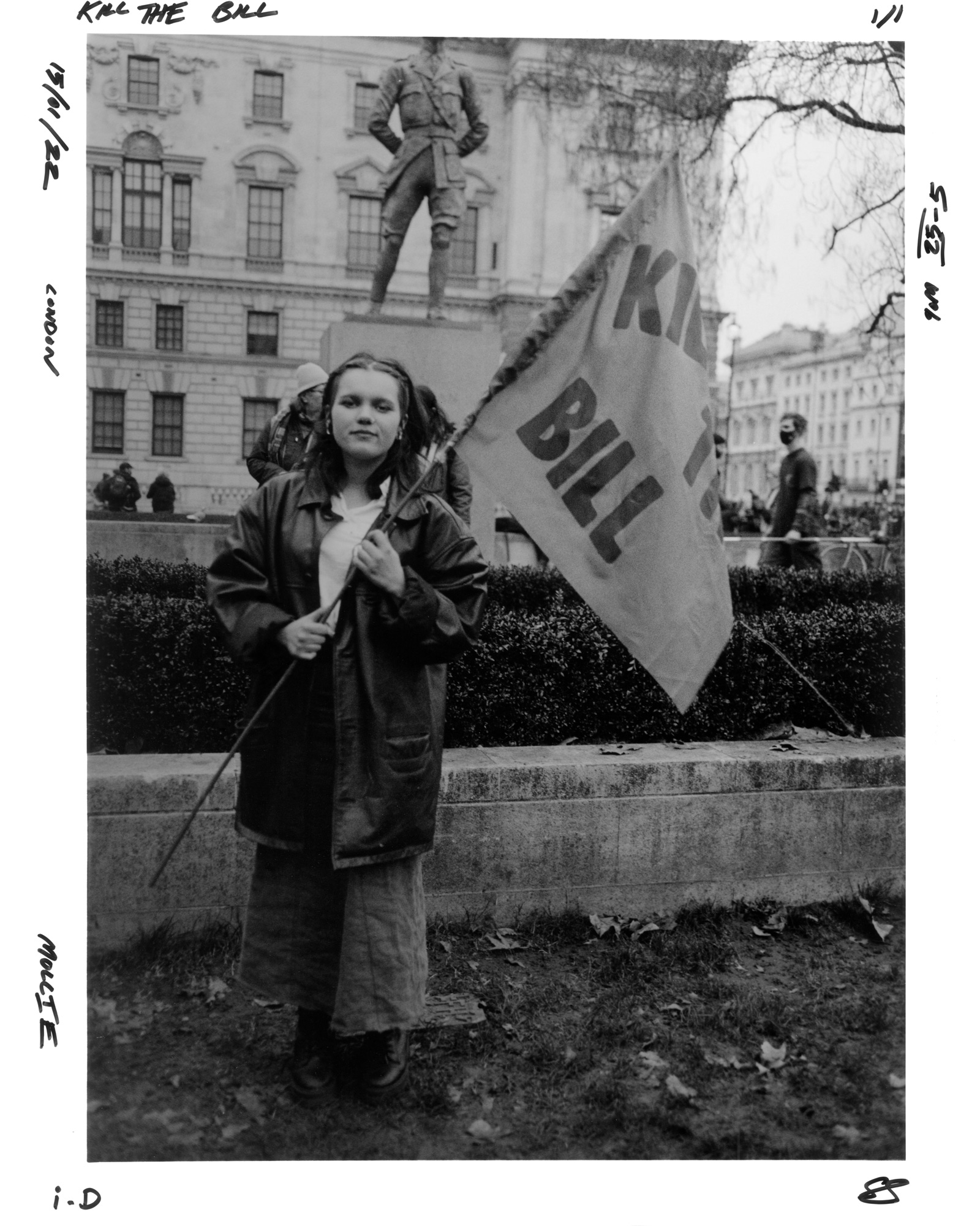 Protester holding a flag saying