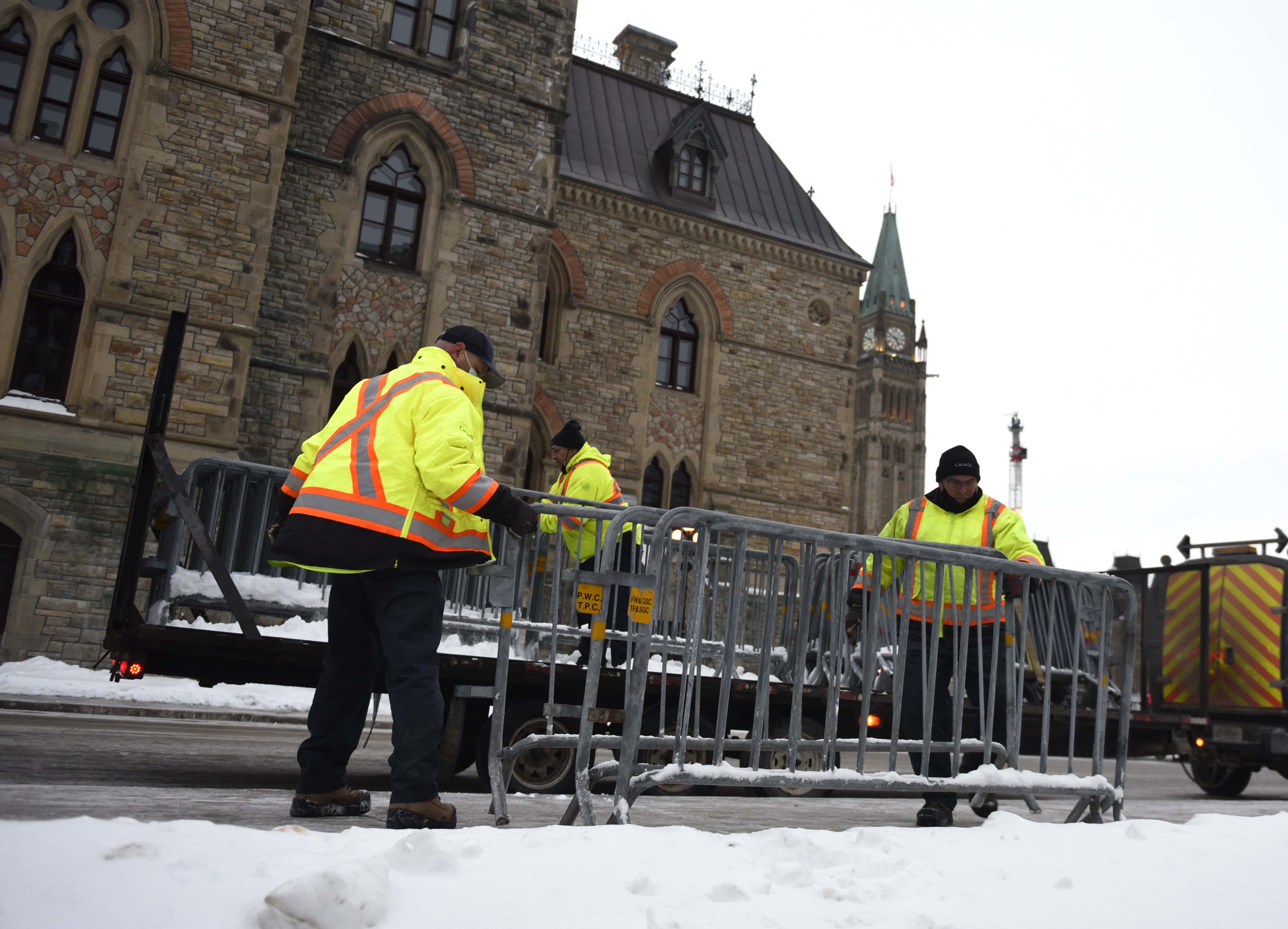 Workers set up barricades in front of Parliament. Photo by the Canadian Press
