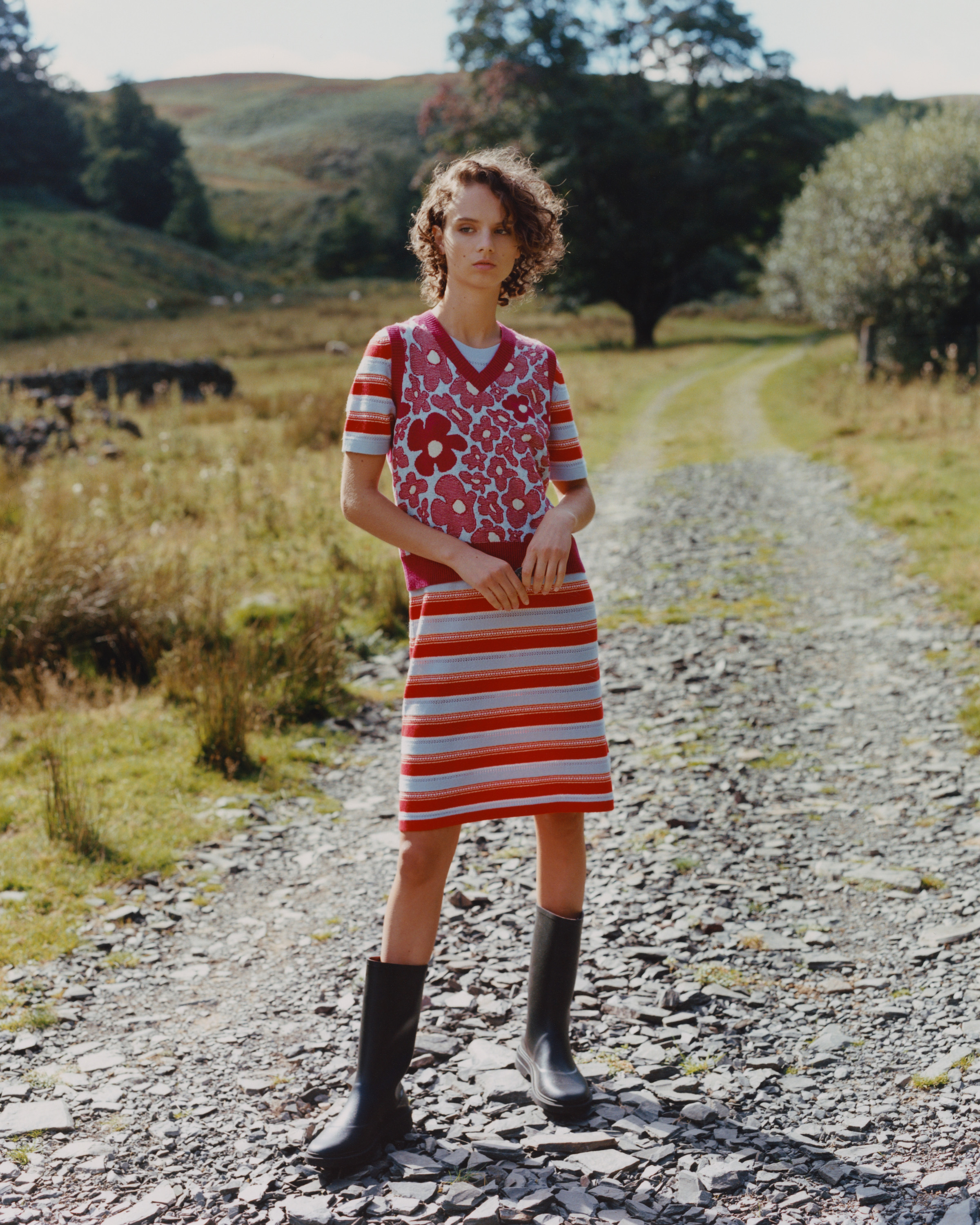a model wearing a striped cashmere dress in the scottish countryside
