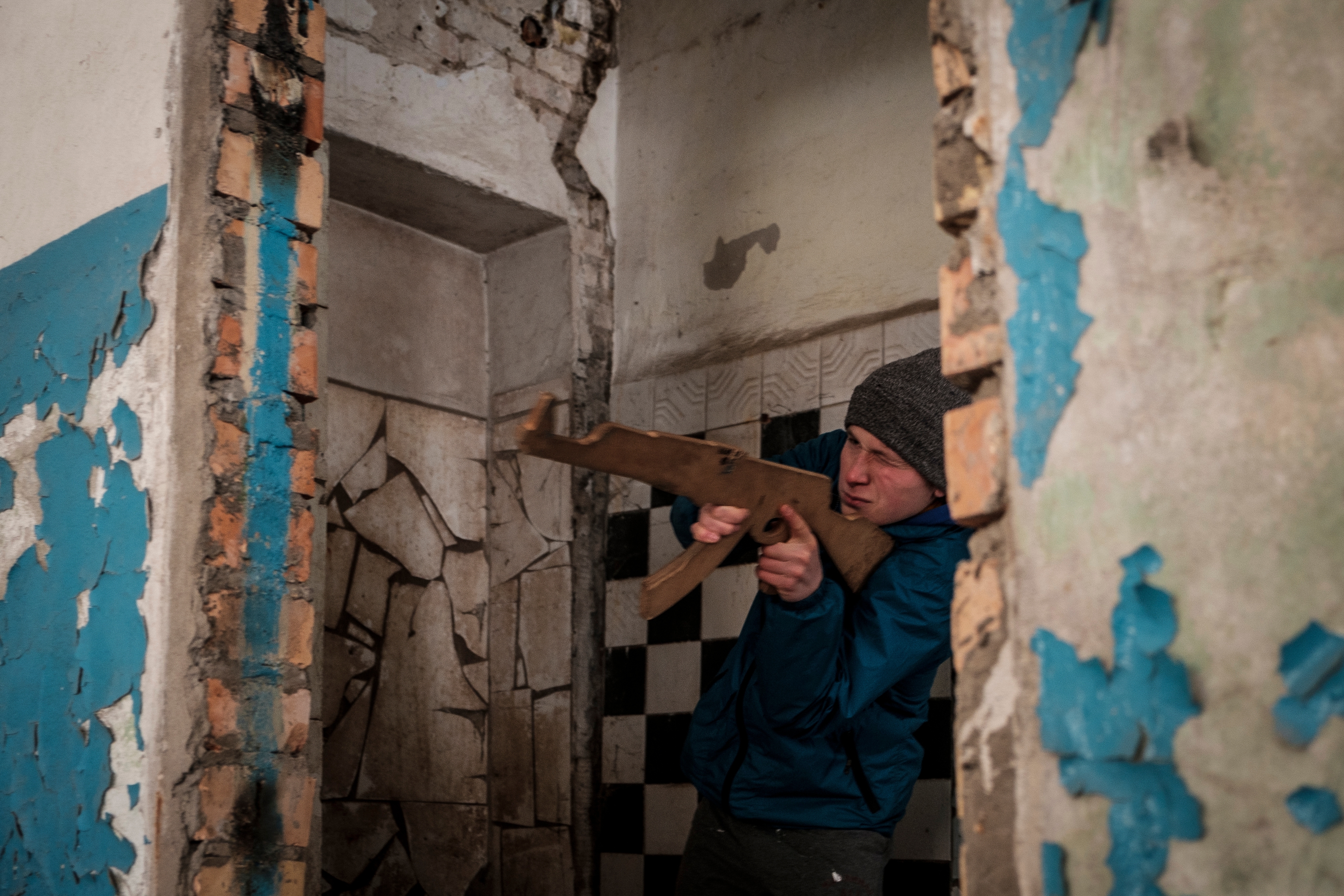 A participant learns how to handle a firearm during an introductory level military and first aid training for civilians by the Azov regiment of the National Guard of Ukraine at their base in Kyiv, Ukraine