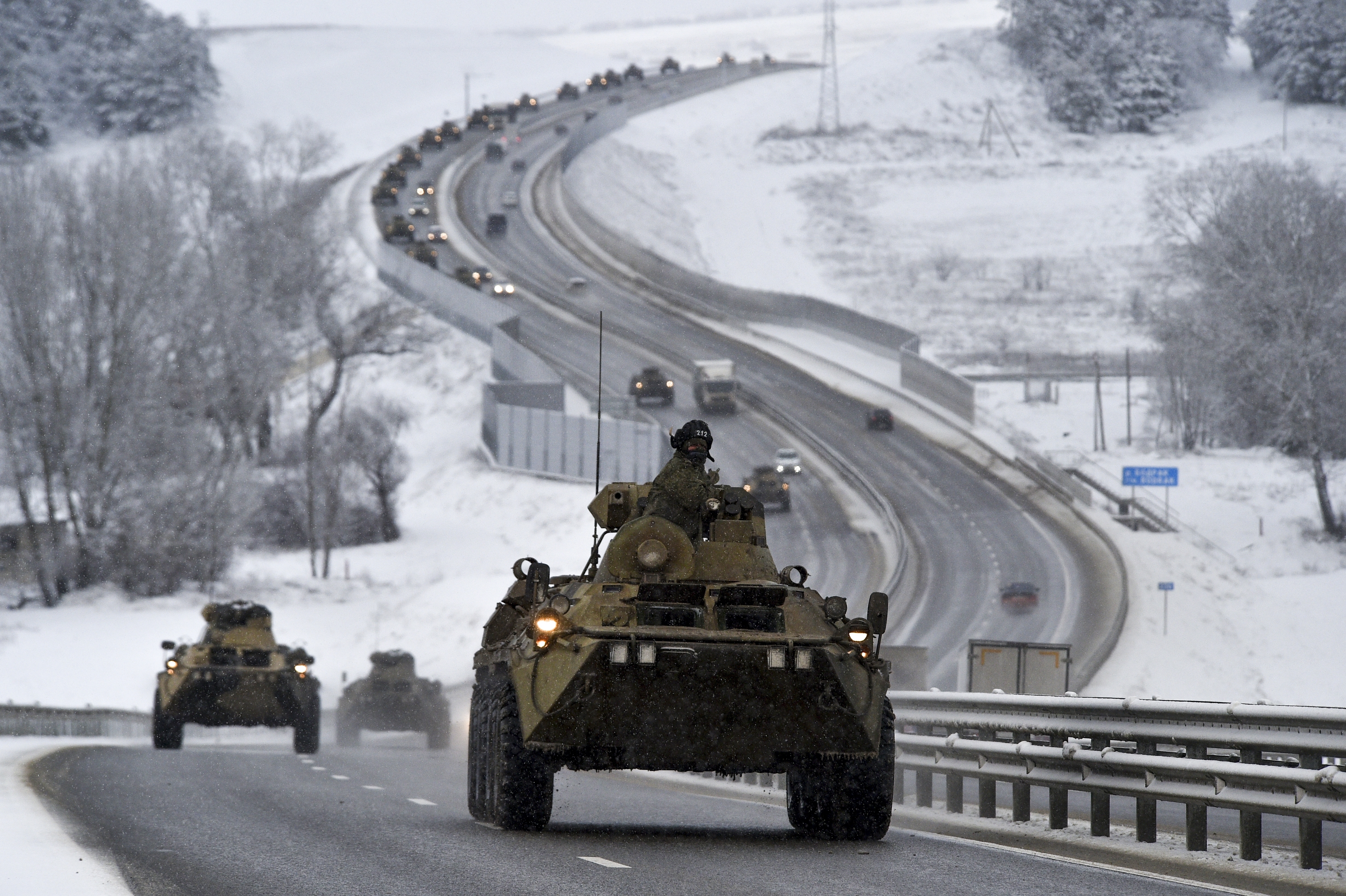 A convoy of Russian armored vehicles moves along a highway in Crimea, Tuesday, Jan. 18, 2022.