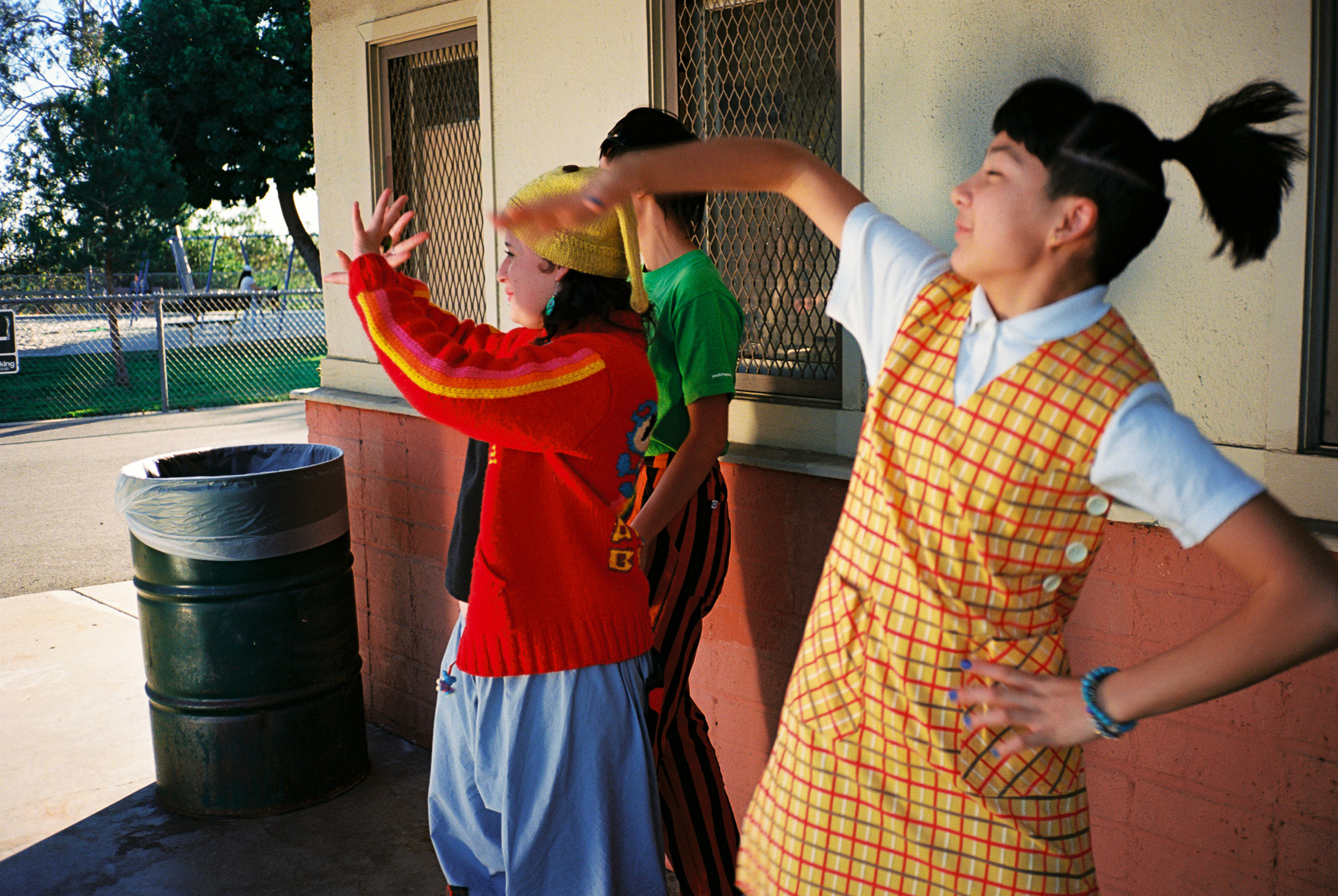 The Linda Lindas are captured mid-dance move in an LA park