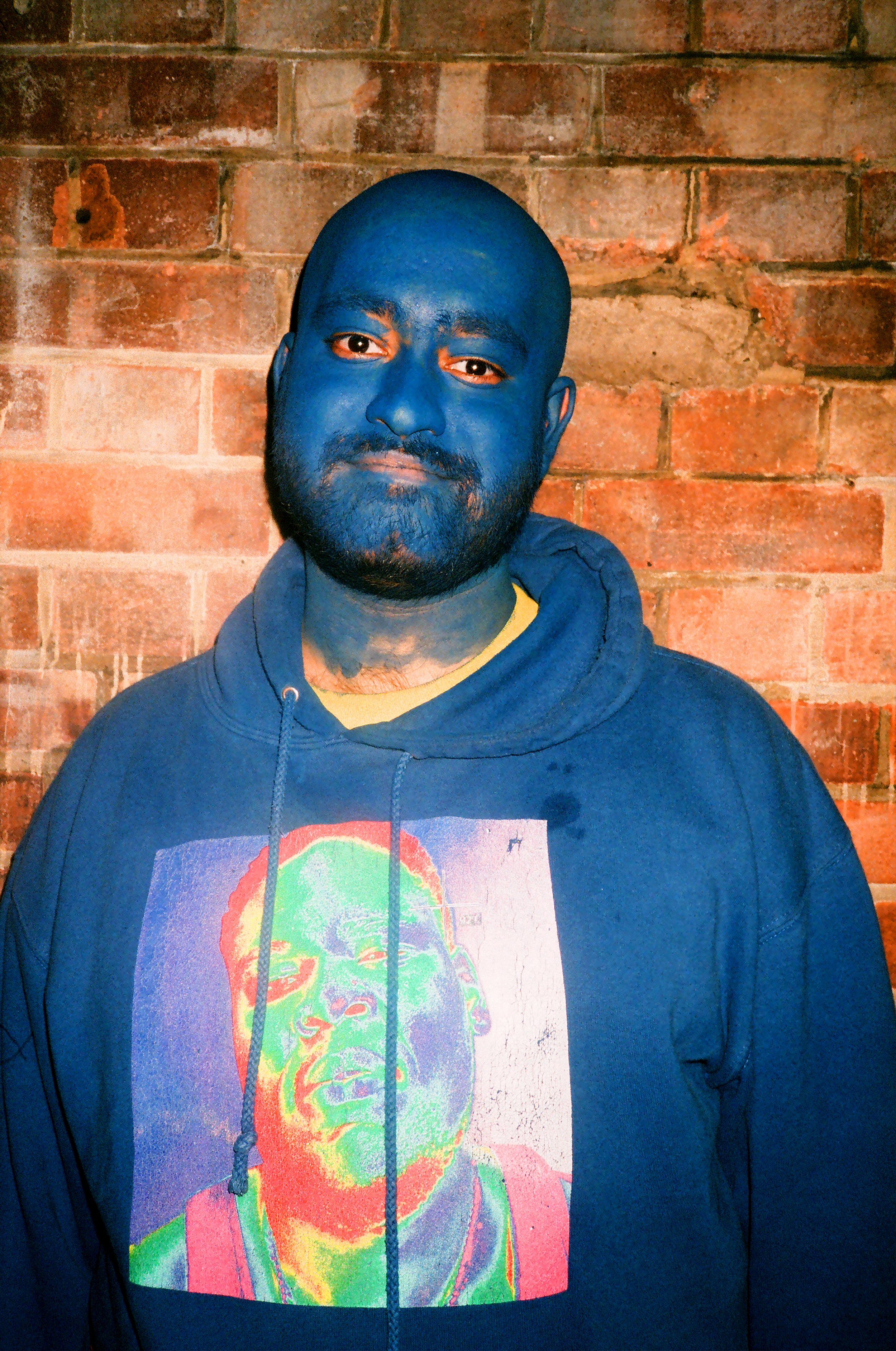 person with blue face paint at brockhampton show