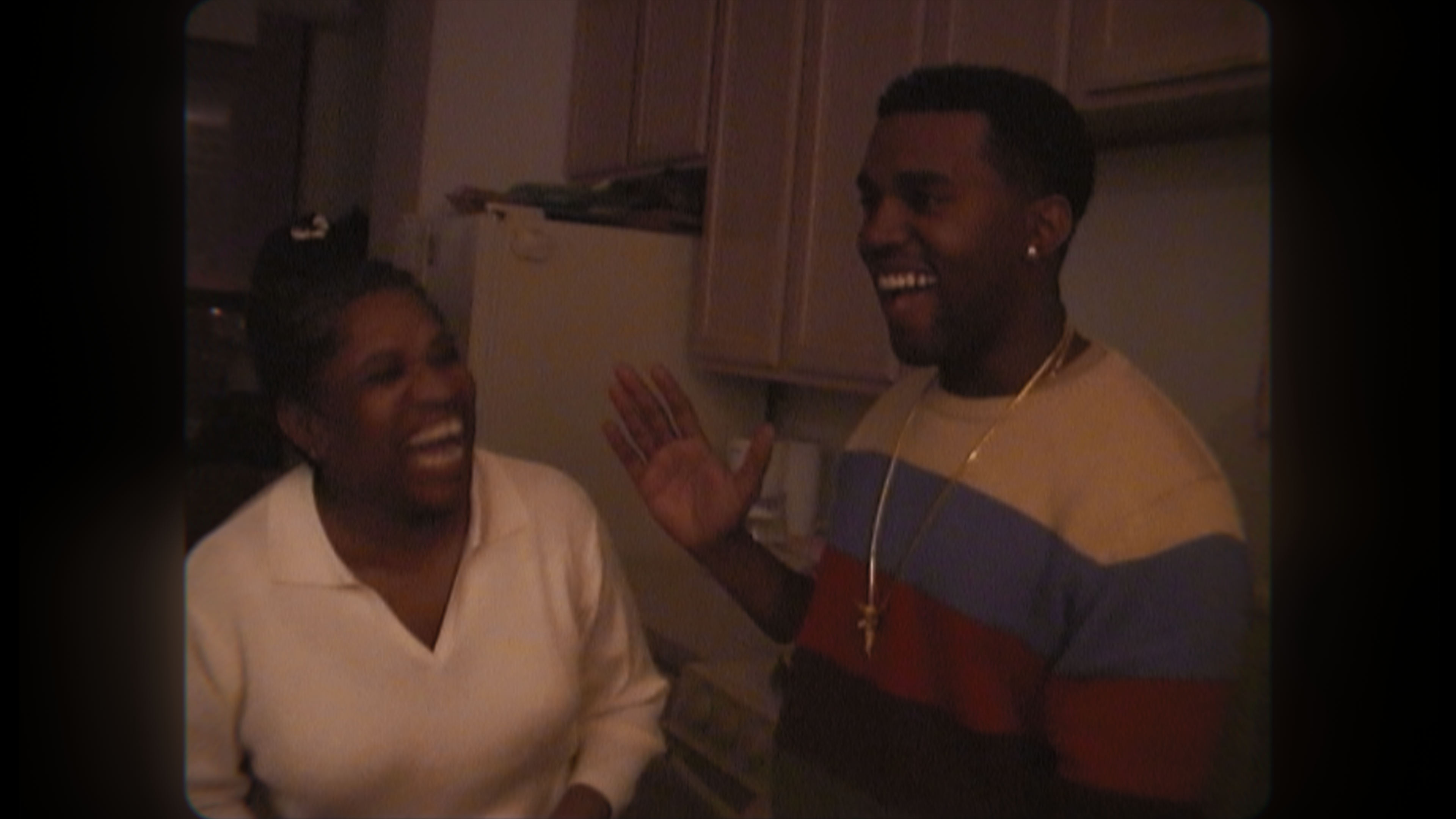 Kanye West laughing with his late mother, Donda West.