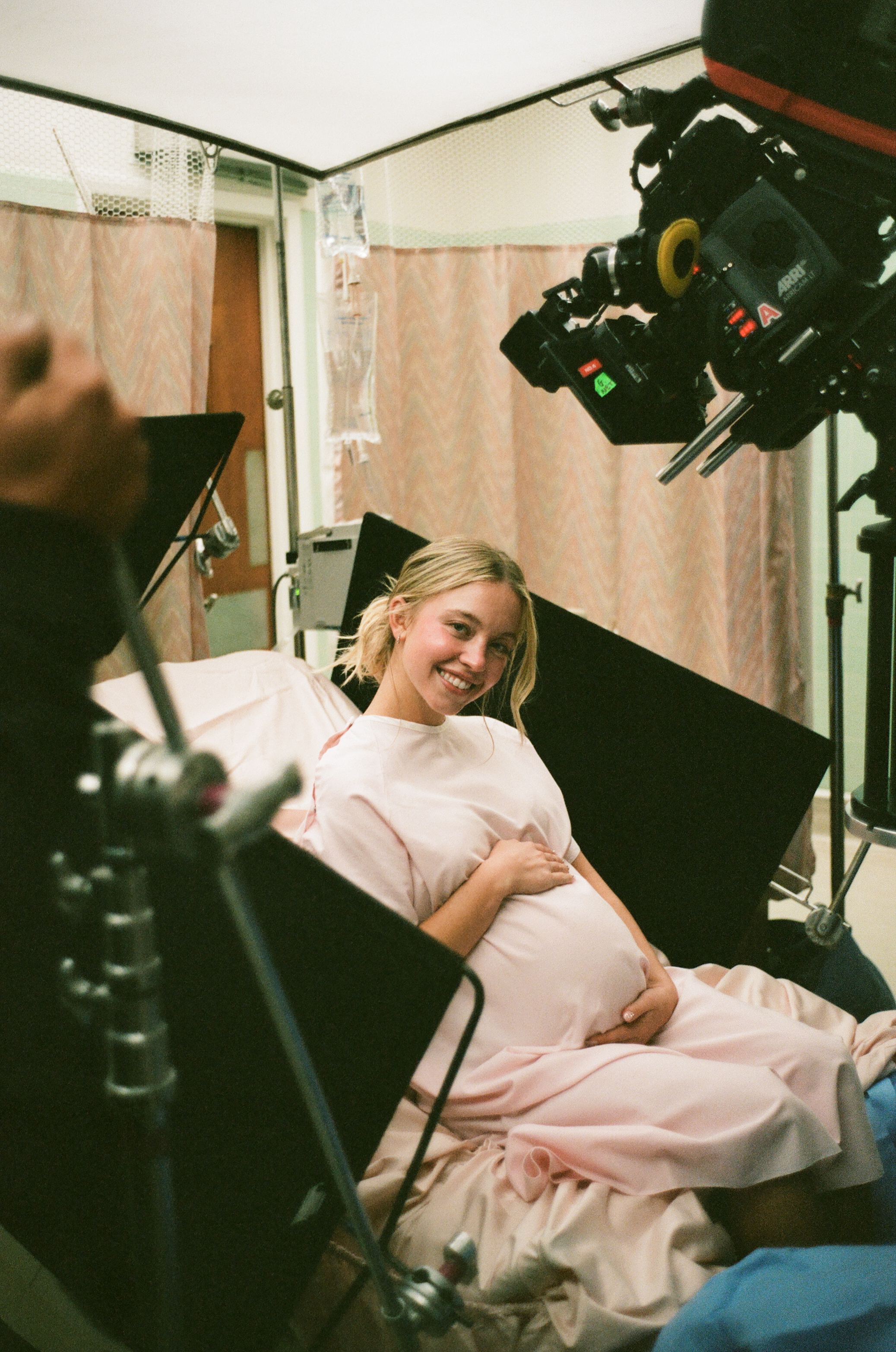 Sydney Sweeney poses with a fake pregnant belly on a euphoria set