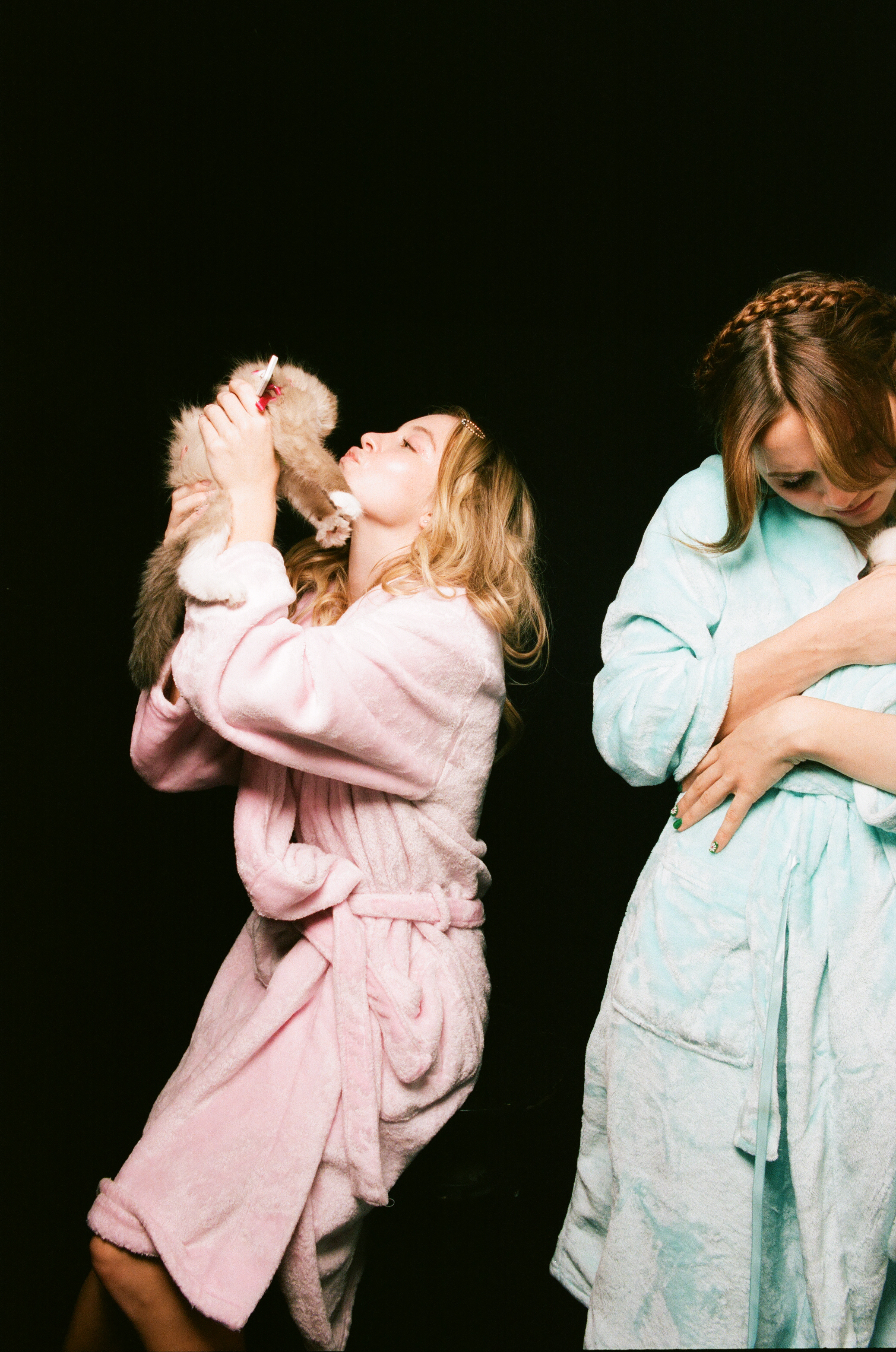 Sydney Sweeney and Maude Apatow hug animals in dressing gowns 