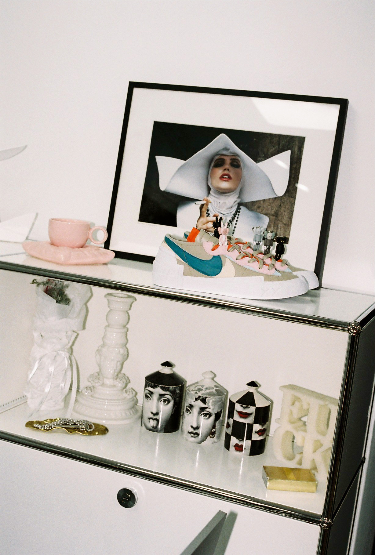 tidy shelves full of candles, jewellery and a pair of clean sneakers