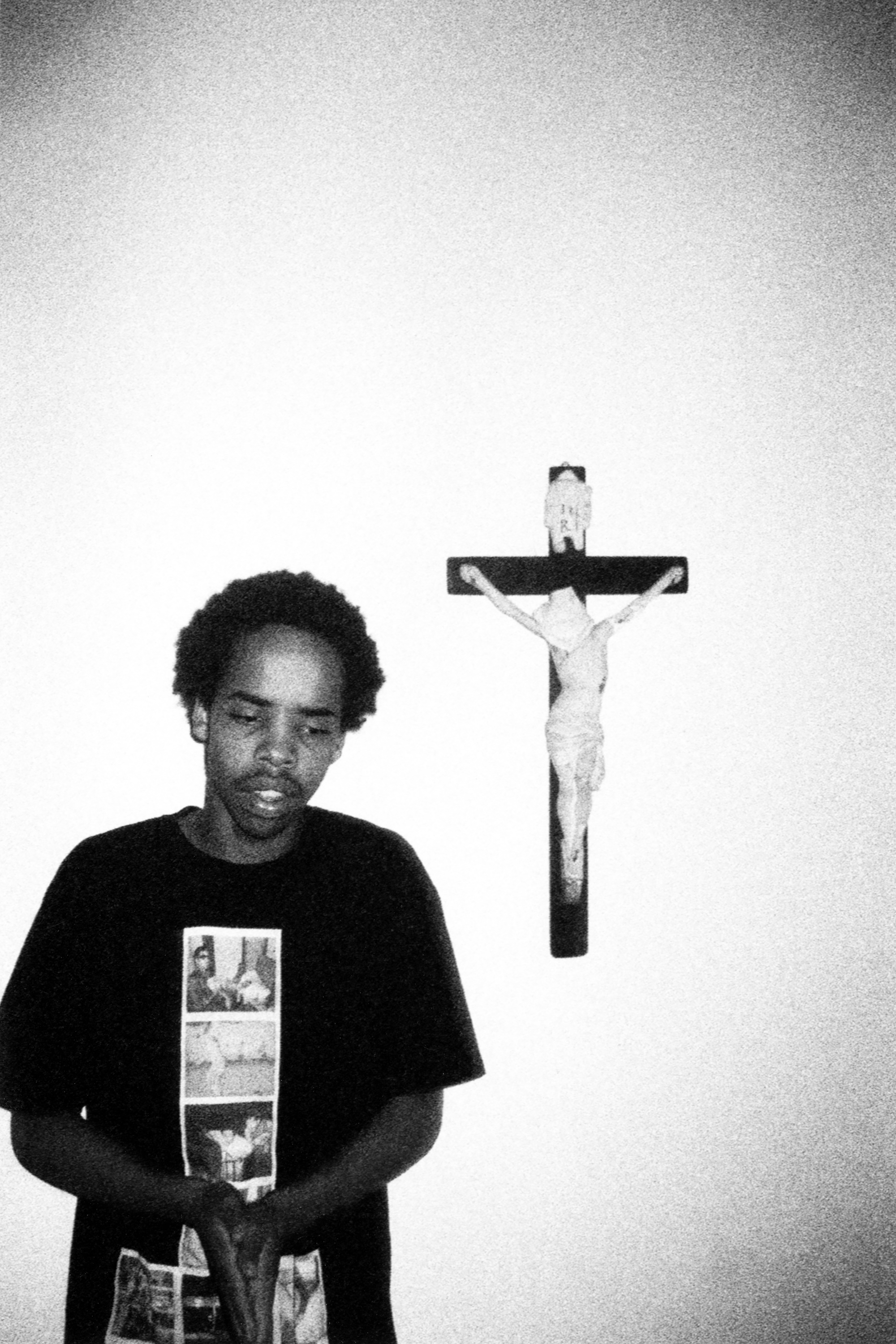 a black and white photo of a skate in front of a crucifix