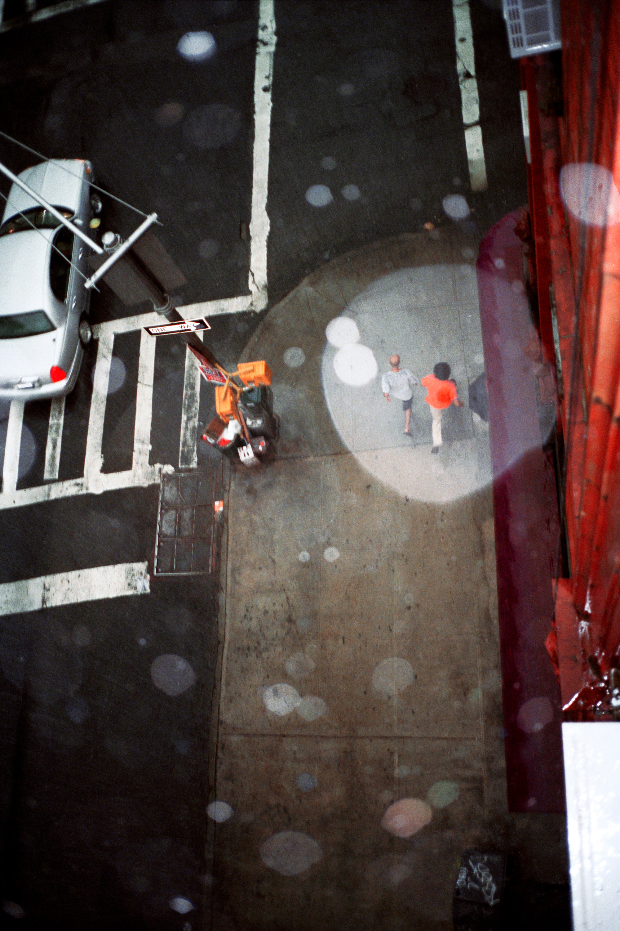 looking down on a new york city street while it's raining by jason dill