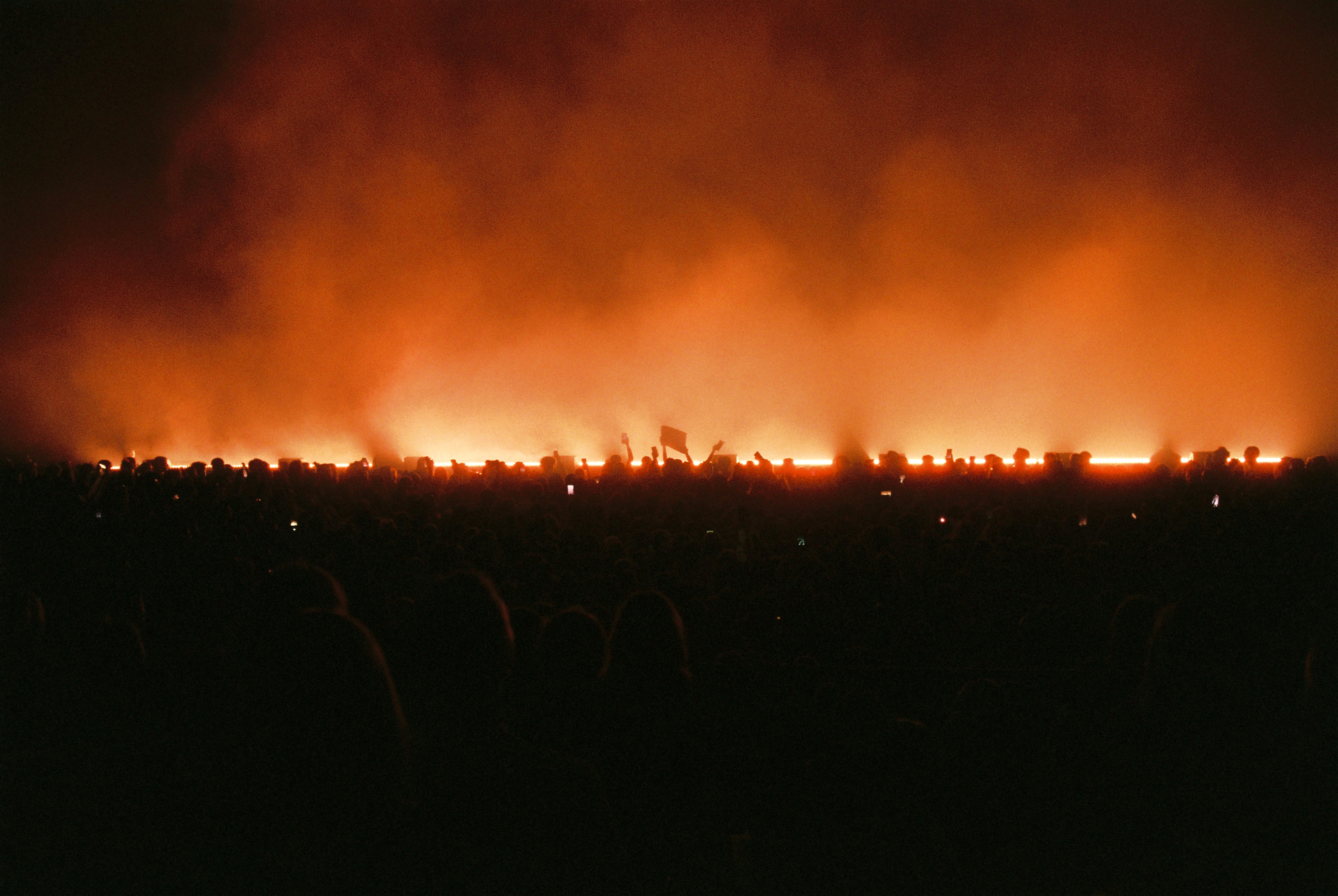a smokey illuminated crowd scene before an Angele concert