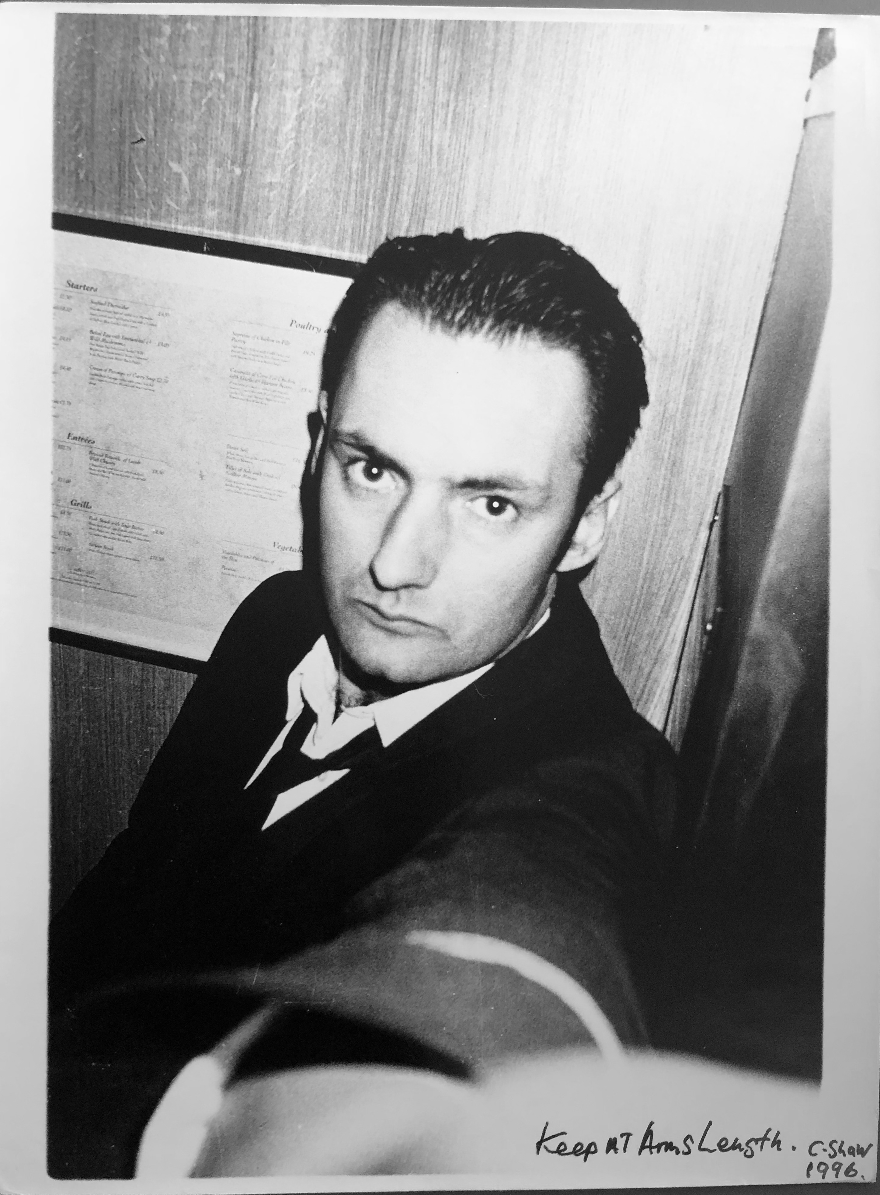 black-and-white image of a hotel porter taking a selfie