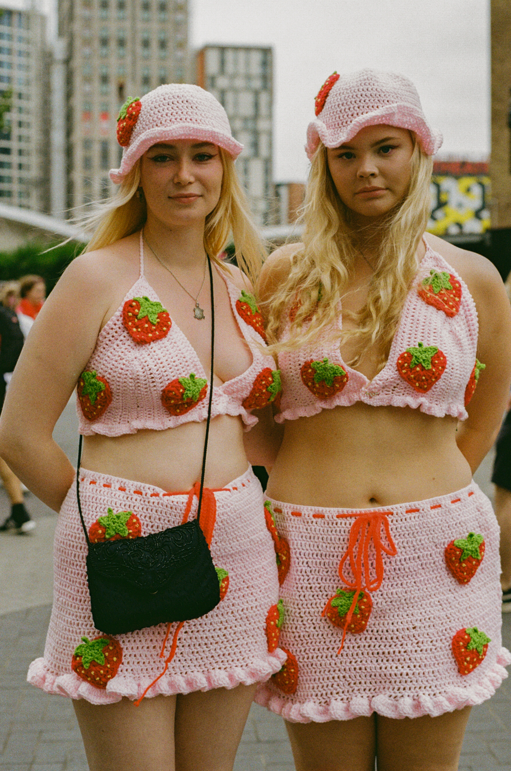two harry styles fans wearing strawberry crochet looks