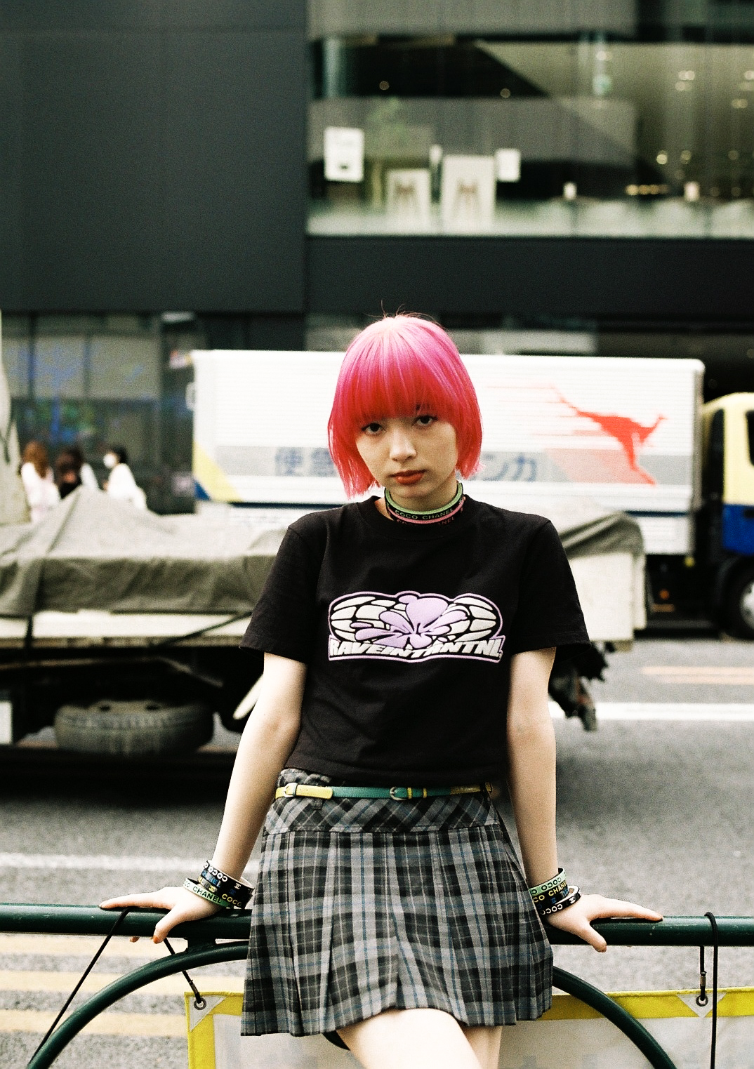 manon sitting on a barrier in the street