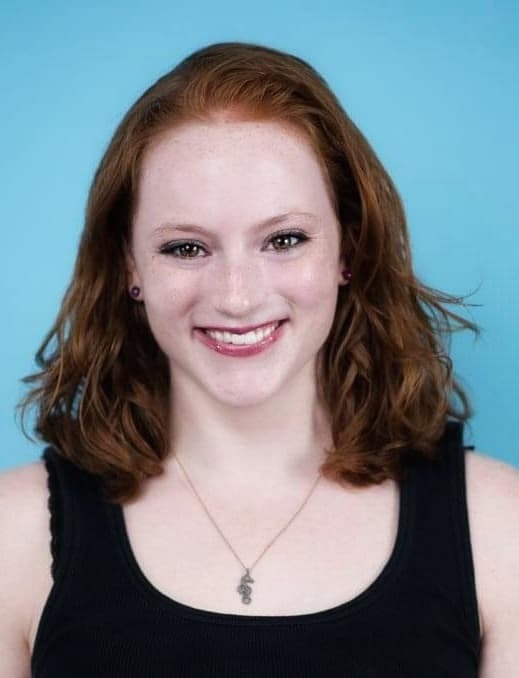 A redhead woman smiling