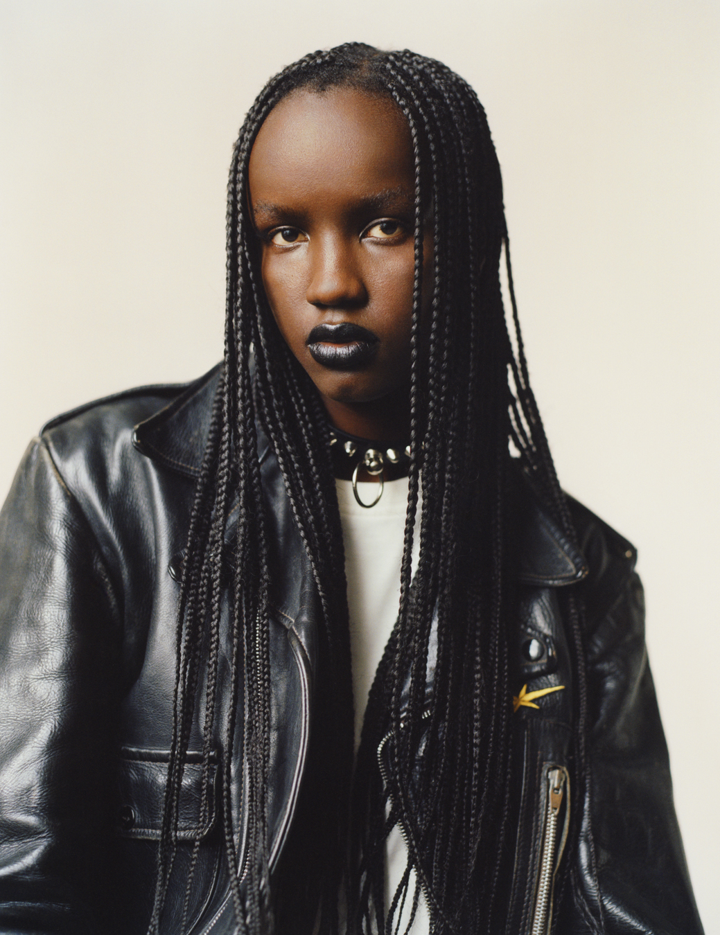 Model wearing white top, leather jacket and choker in case of ID 369 Earthrise