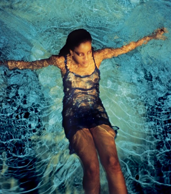 a girl swimming in a pool at night wearing a sheer dress by ella simone