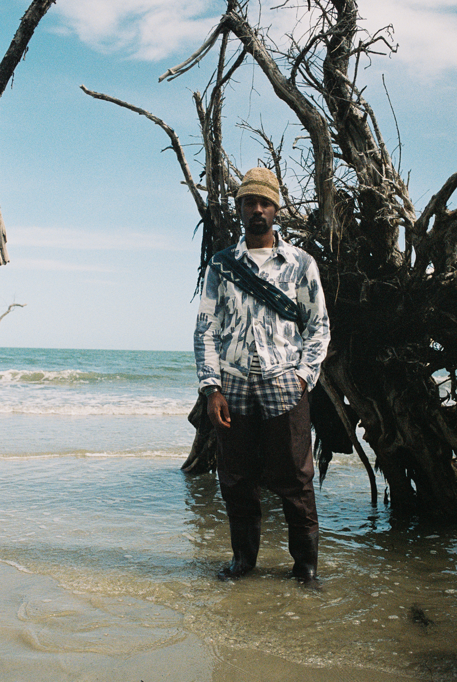 model wearing denim tears clothing in the ocean