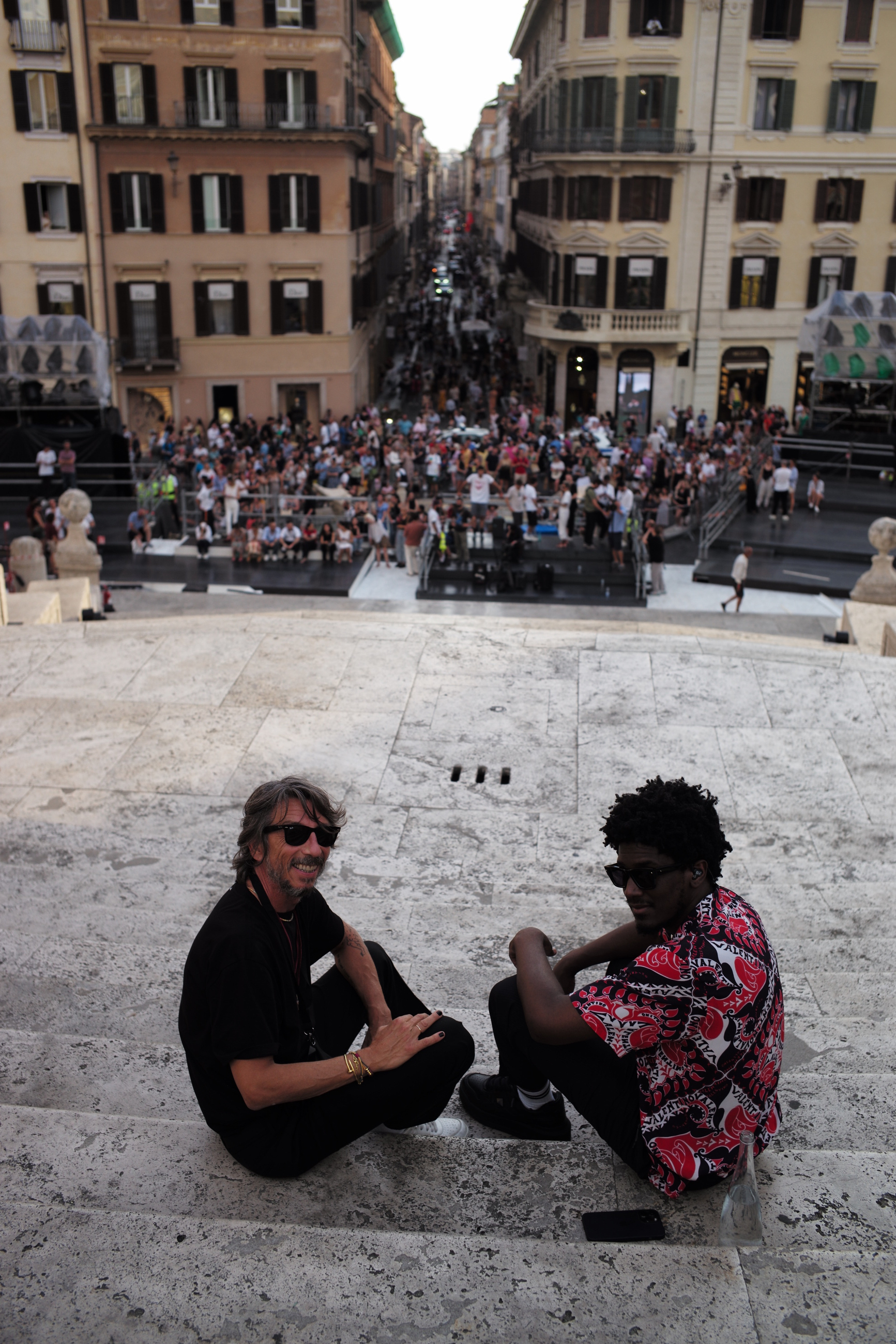the producer Labrinth and Pierpaolo Piccioli sitting on the spanish steps in rome, before the Valentino AW22 show
