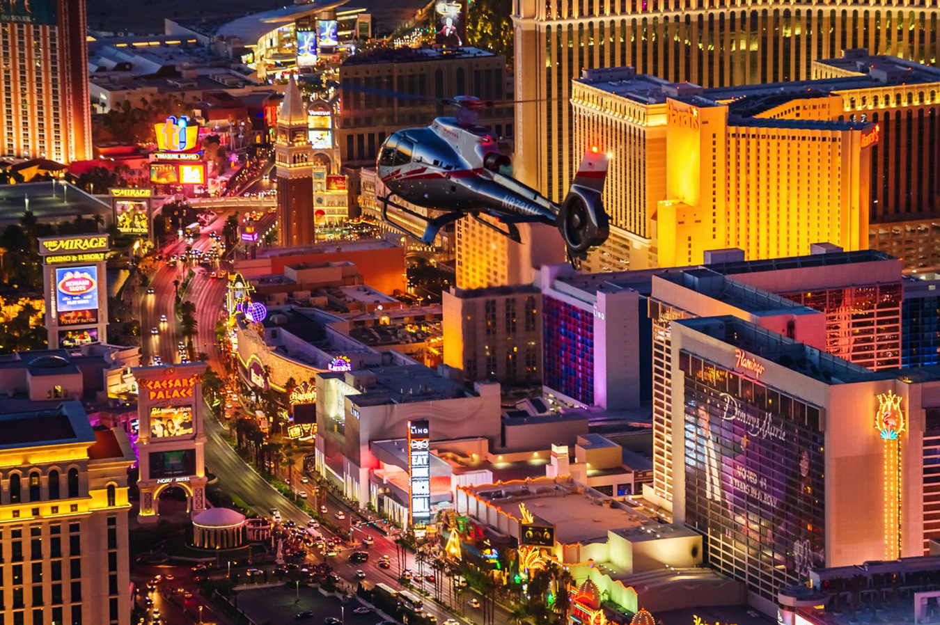 A helicopter soaring above the glittering city of Las Vegas