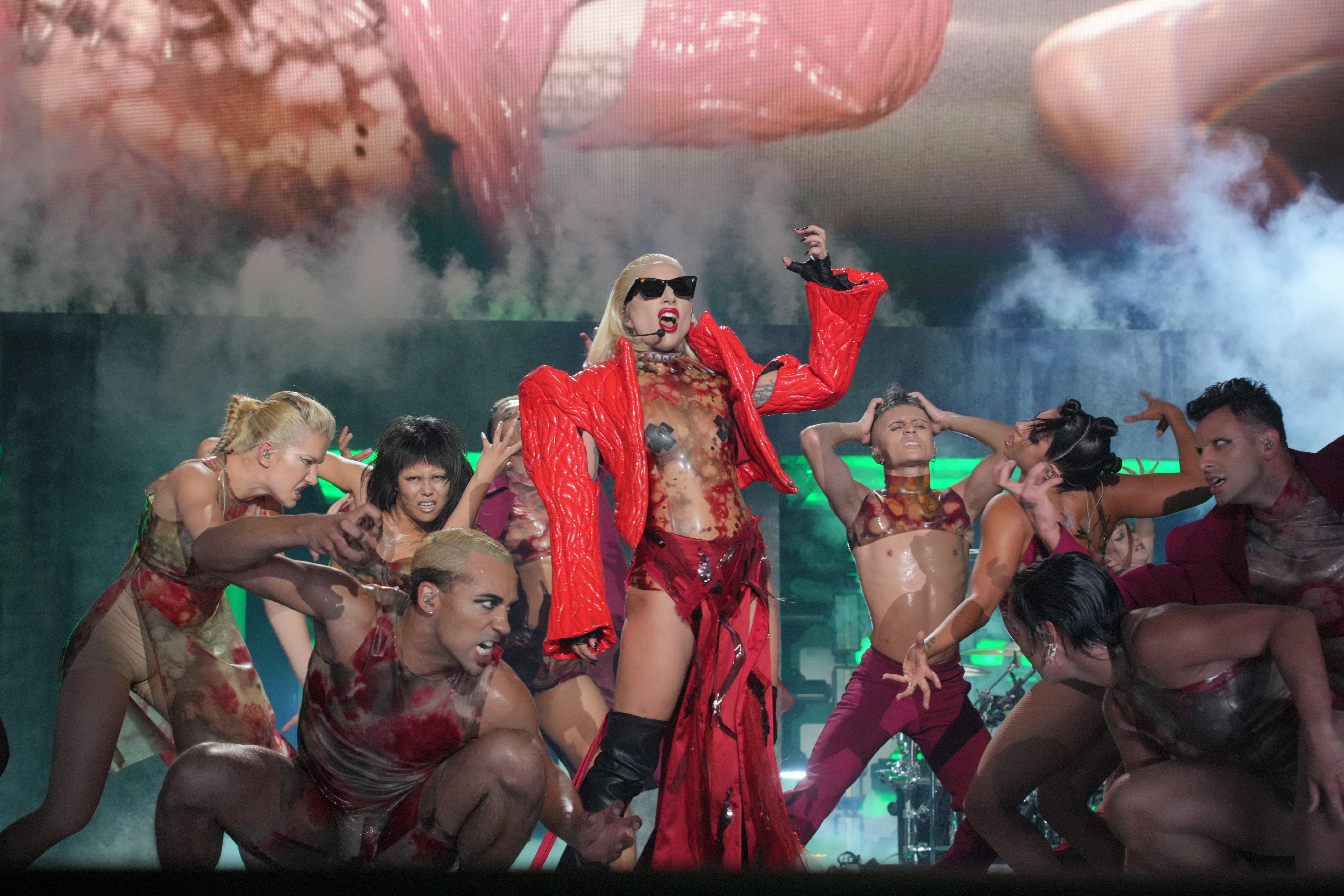 lady gaga chromatica ball  in a red jacket performing monster 