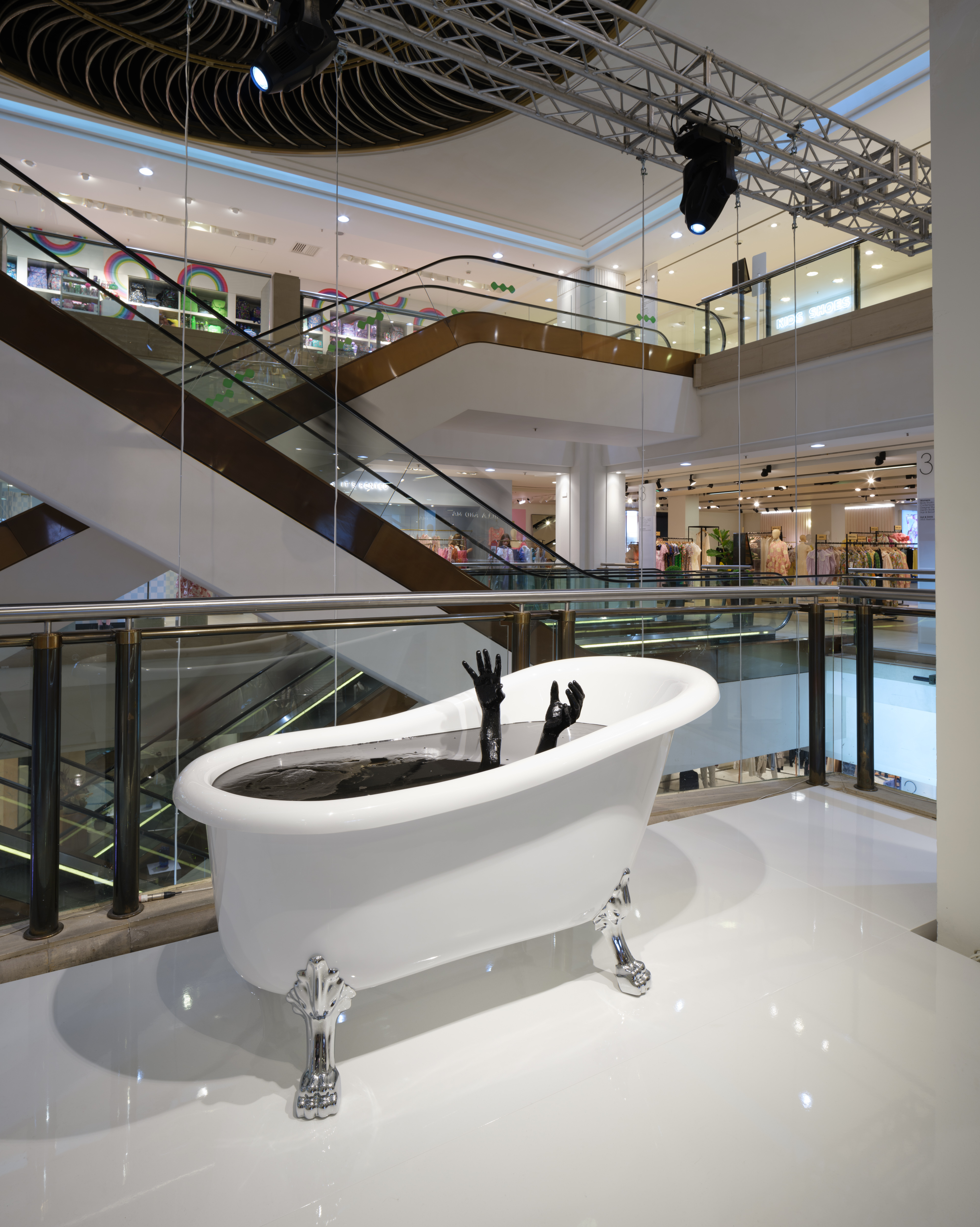 Art installation at Selfridges by Monira Al Qadiri of a person drowning in a bathtub of oil