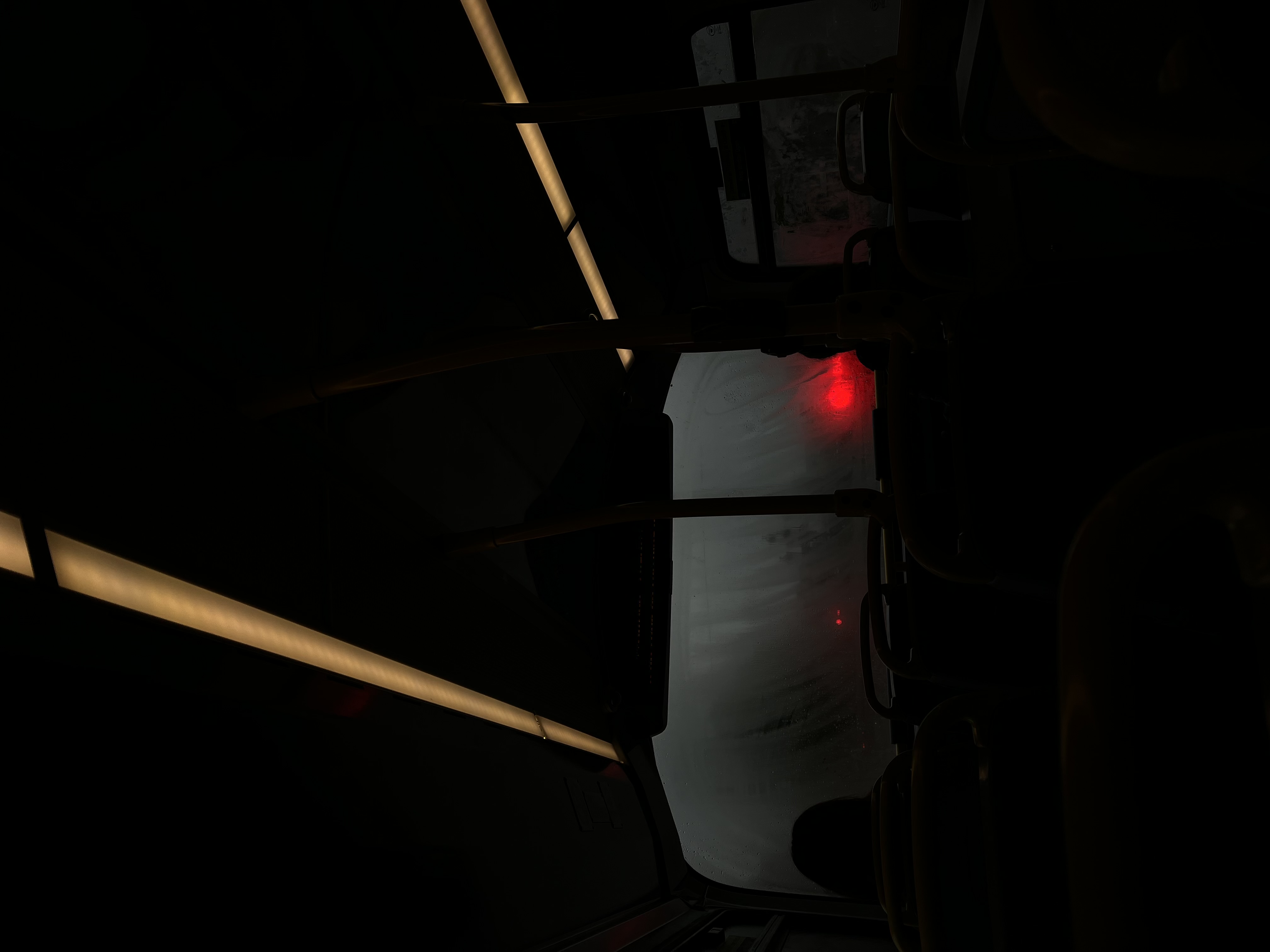 inside a bus looking out the windscreen at night