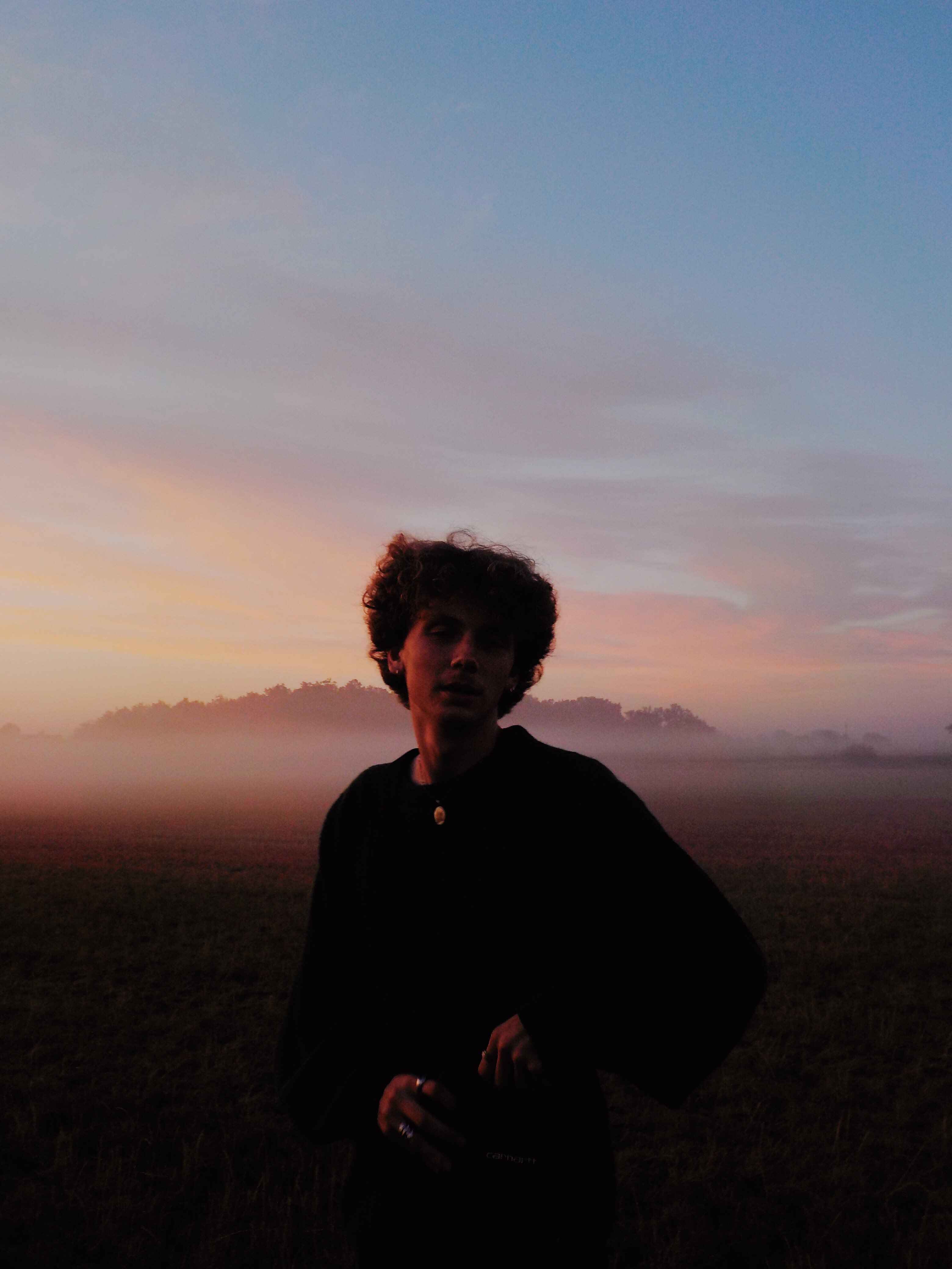 young boy looking at the camera in the early morning