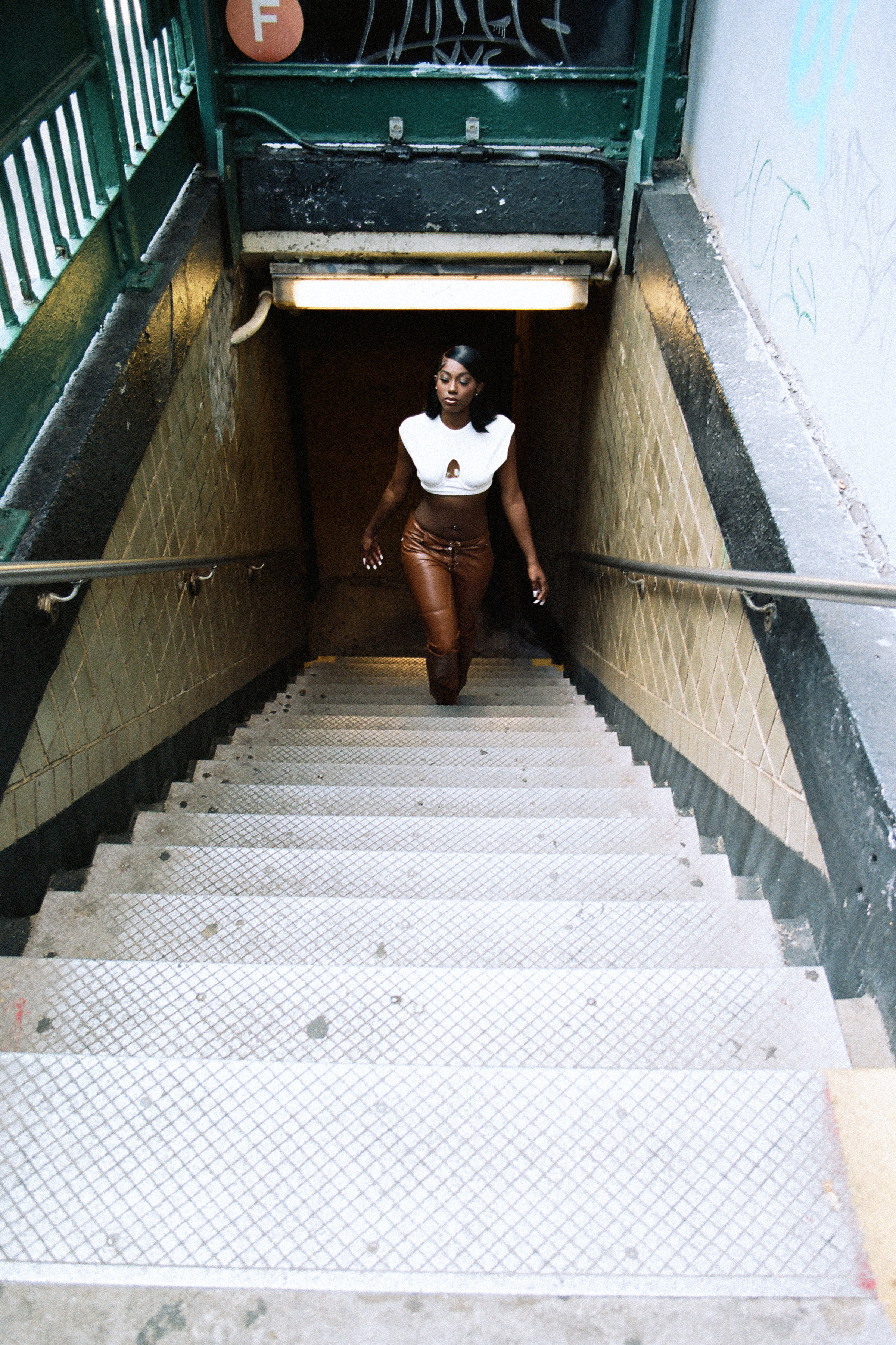 flo milli walking up the nyc subway stairs