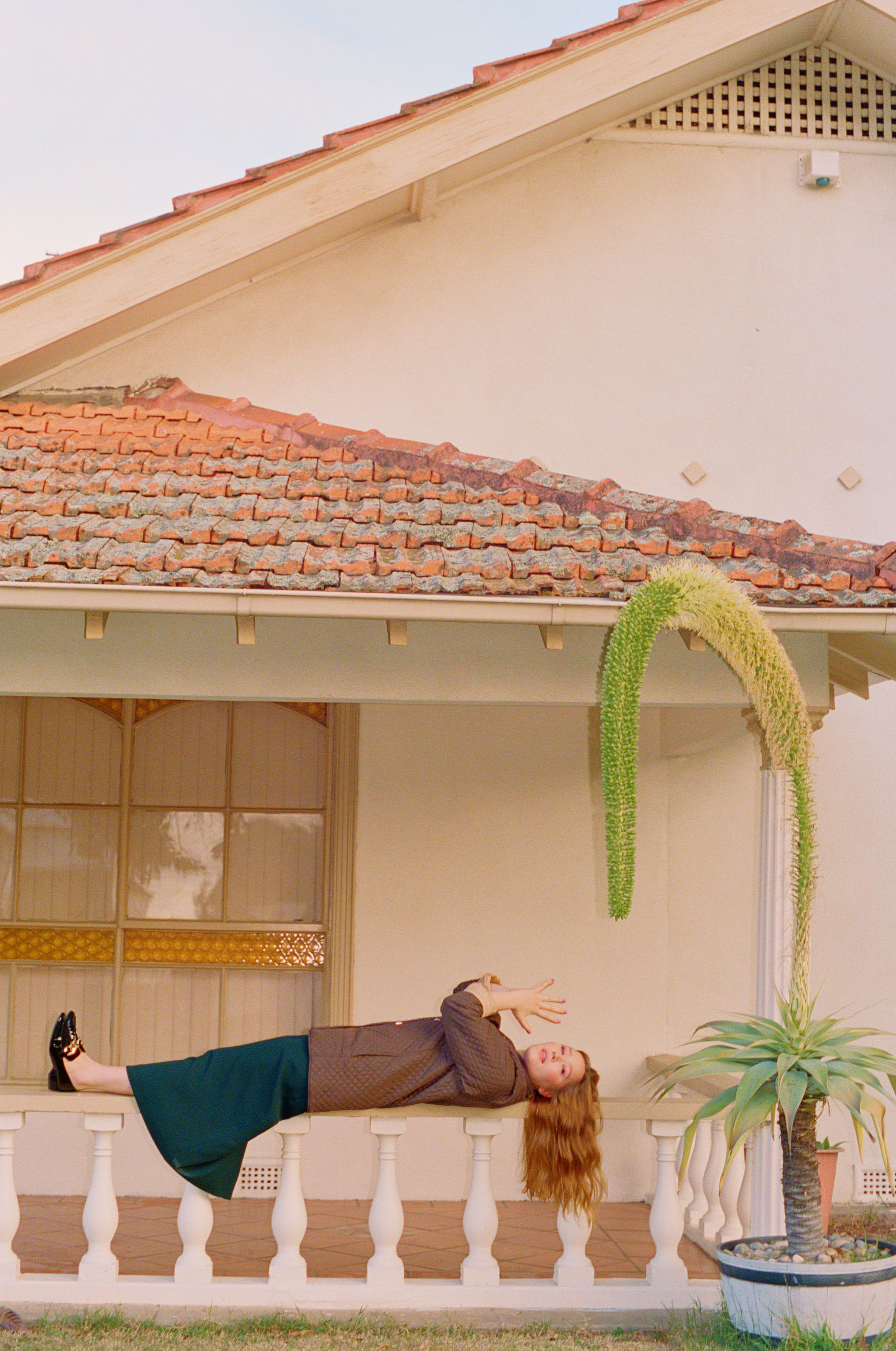 julia jacklin lying on her porch with her hands outstretched in prayer